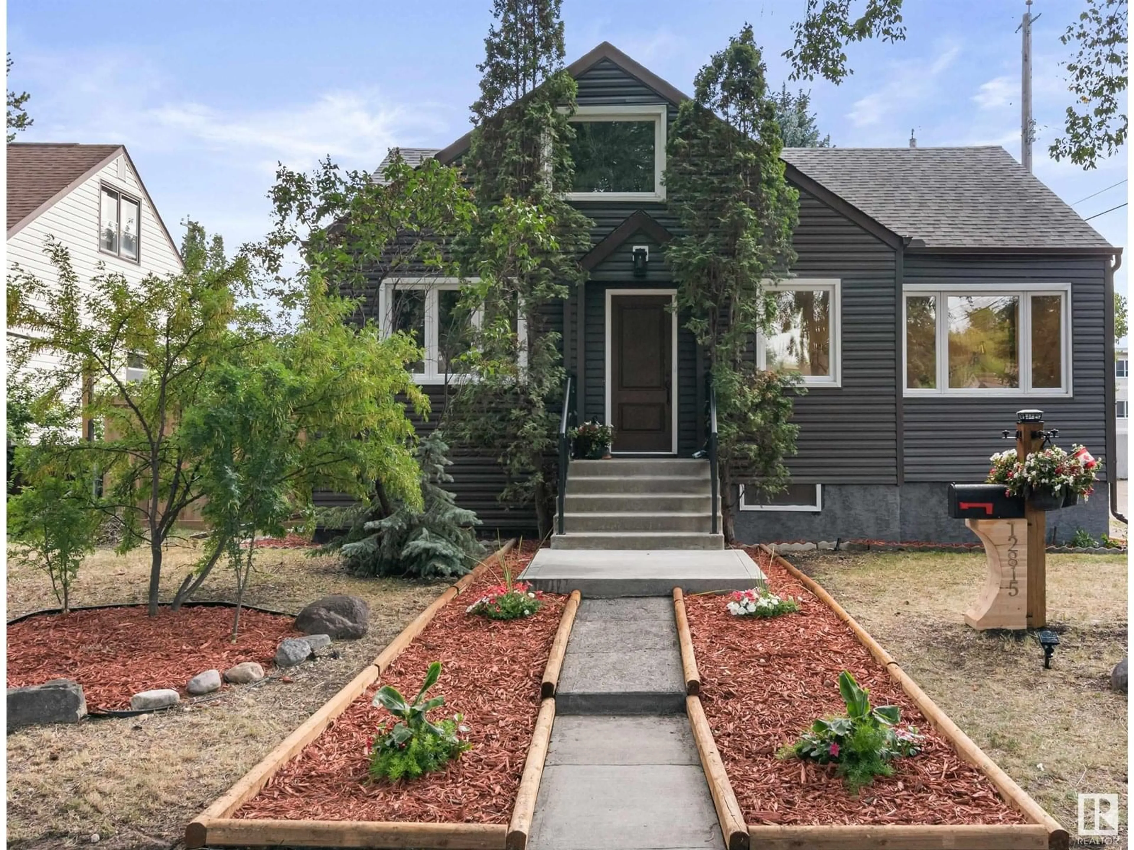 Home with brick exterior material, street for 12815 119 AV, Edmonton Alberta T5L2N1