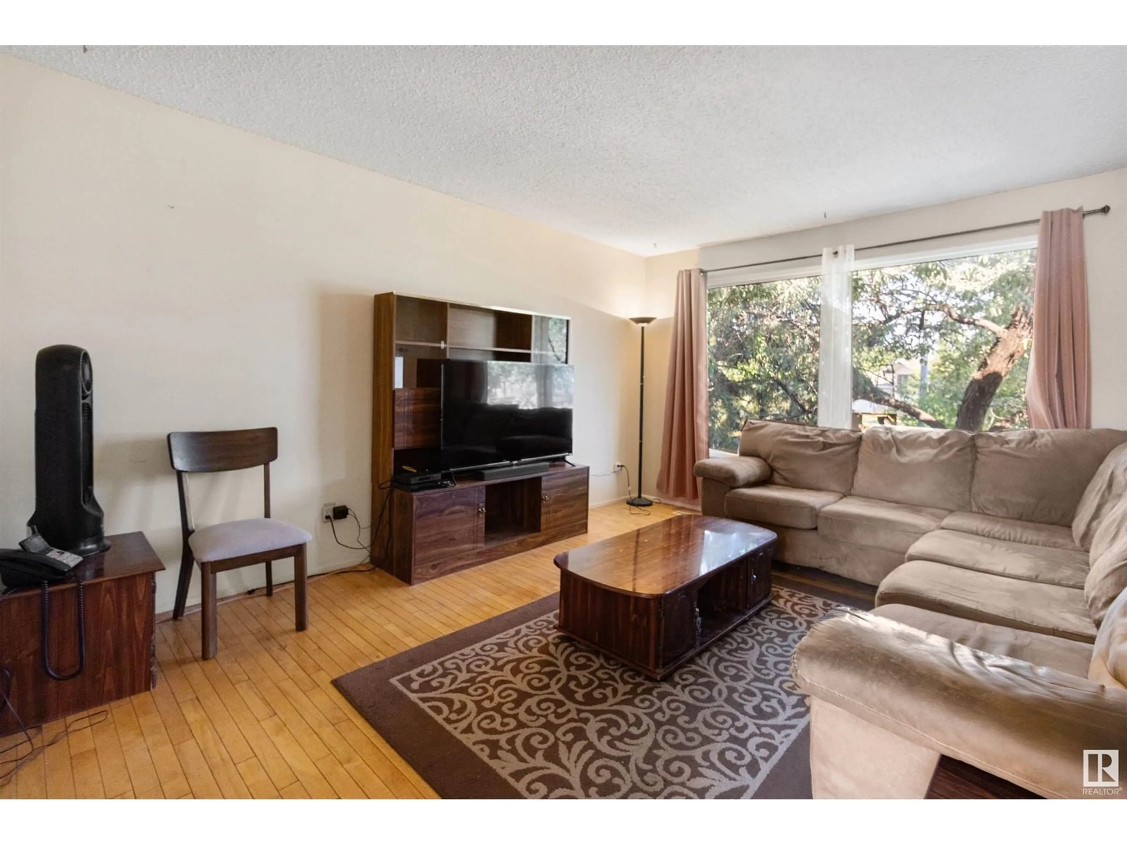 Living room with furniture, wood/laminate floor for NW - 14203 22 ST, Edmonton Alberta T5Y1E4