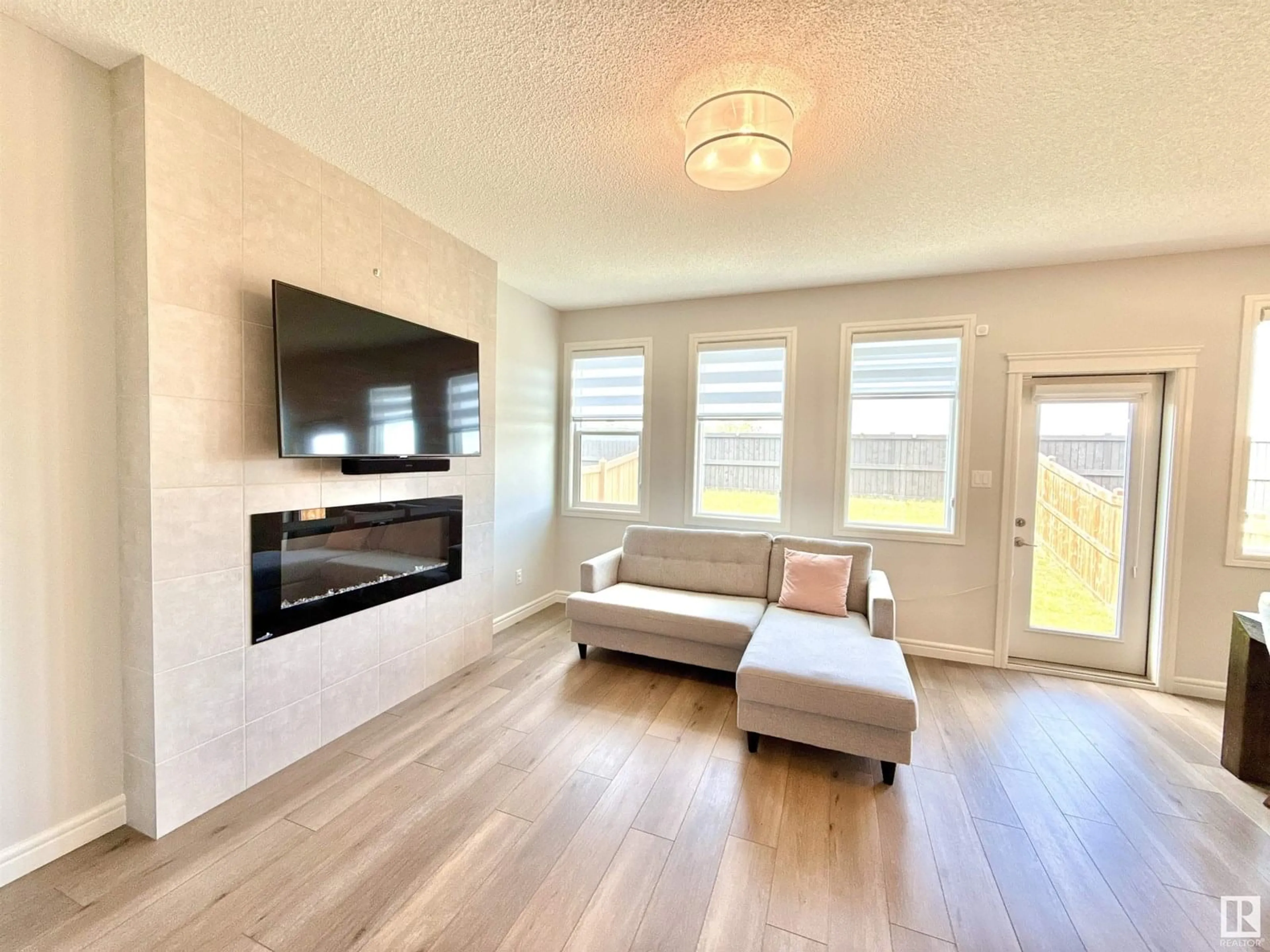 Living room with furniture, wood/laminate floor for 17520 49 ST, Edmonton Alberta T5Y4C6