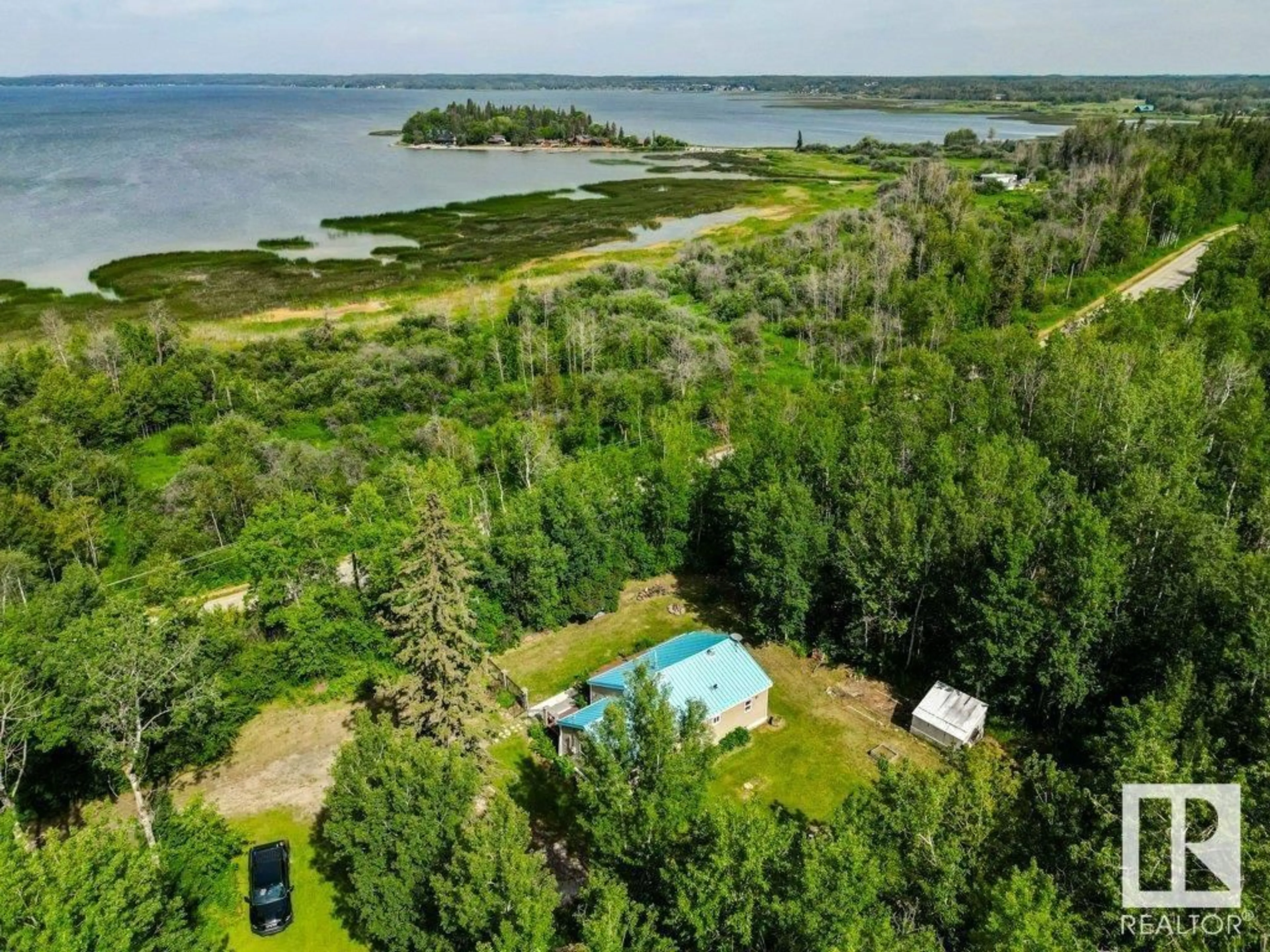 A pic from outside/outdoor area/front of a property/back of a property/a pic from drone, water/lake/river/ocean view for 54503 STE. ANNE TR, Rural Lac Ste. Anne County Alberta T0E1A1