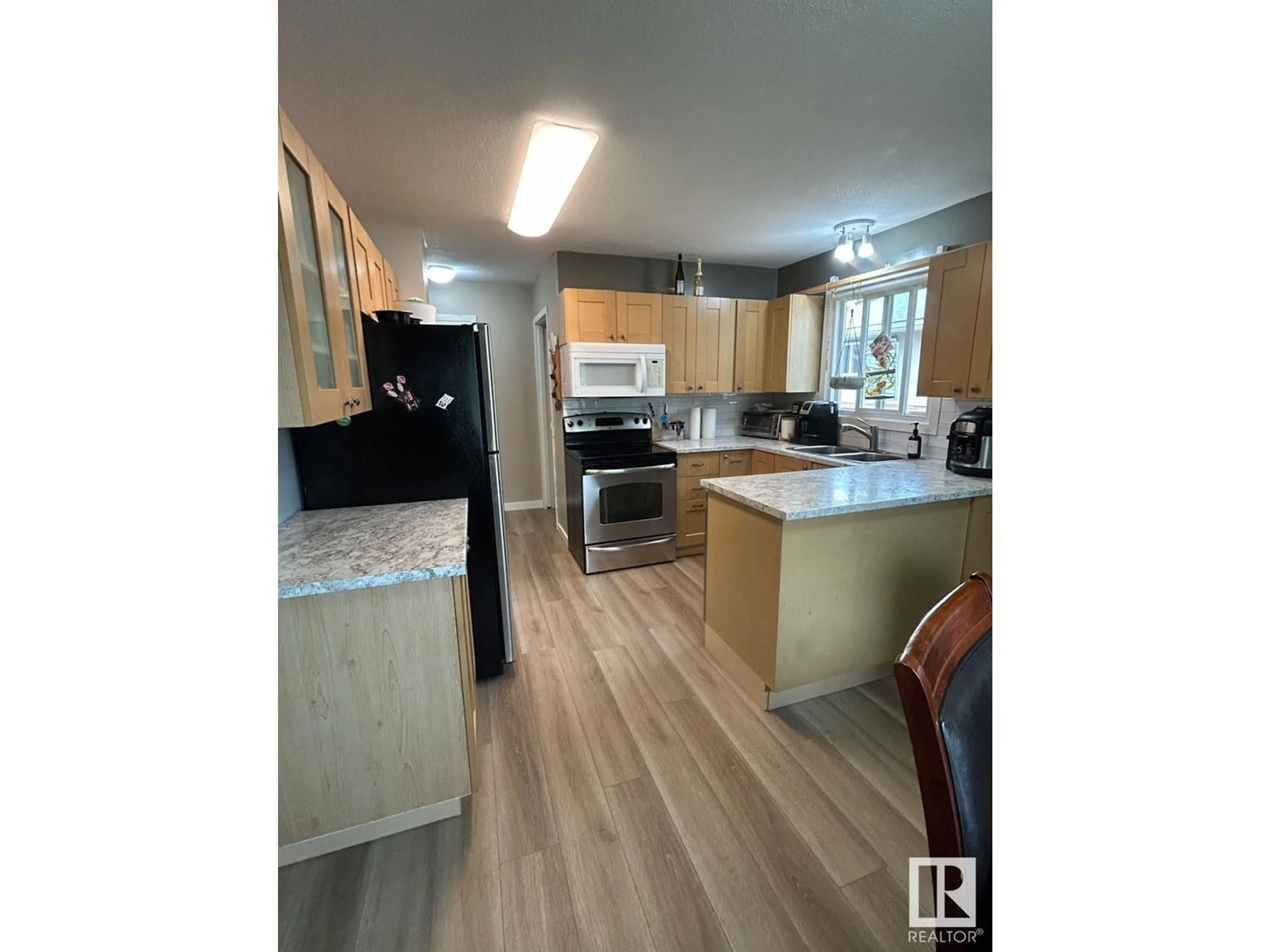 Open concept kitchen, wood/laminate floor for 4908 50 AV, Bon Accord Alberta T0A0K0