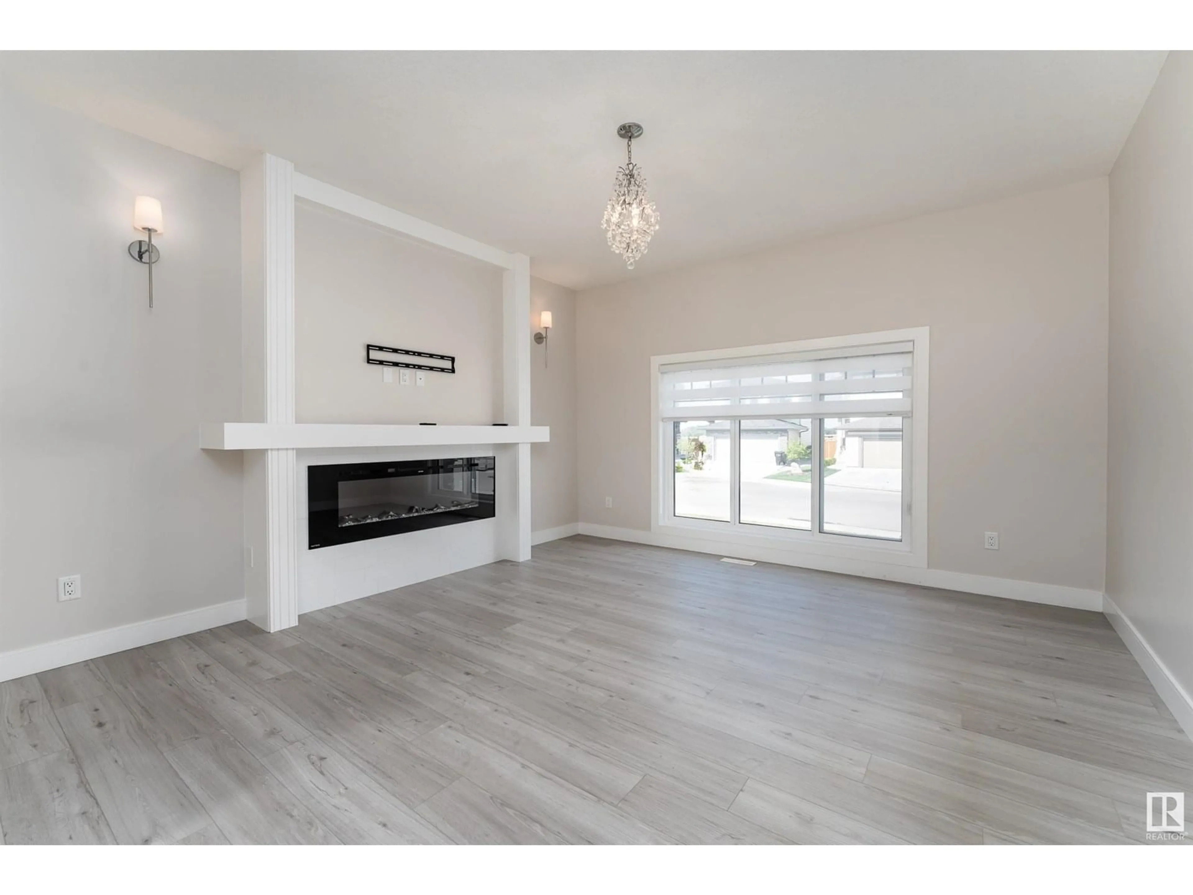 Living room with furniture, wood/laminate floor for 9207 183 AV, Edmonton Alberta T5Z0S6