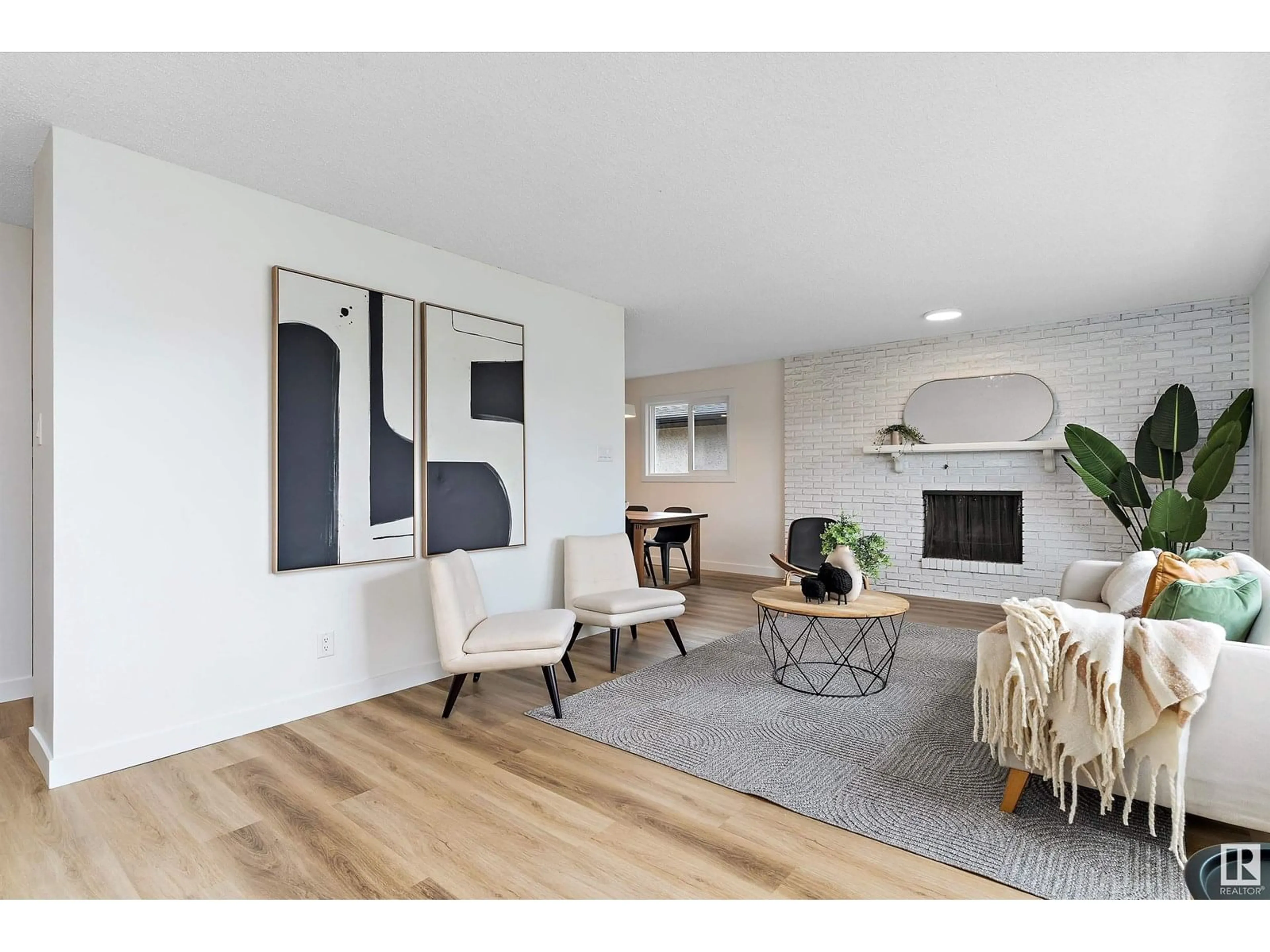 Living room with furniture, wood/laminate floor for 8507 54 ST, Edmonton Alberta T6B1H2