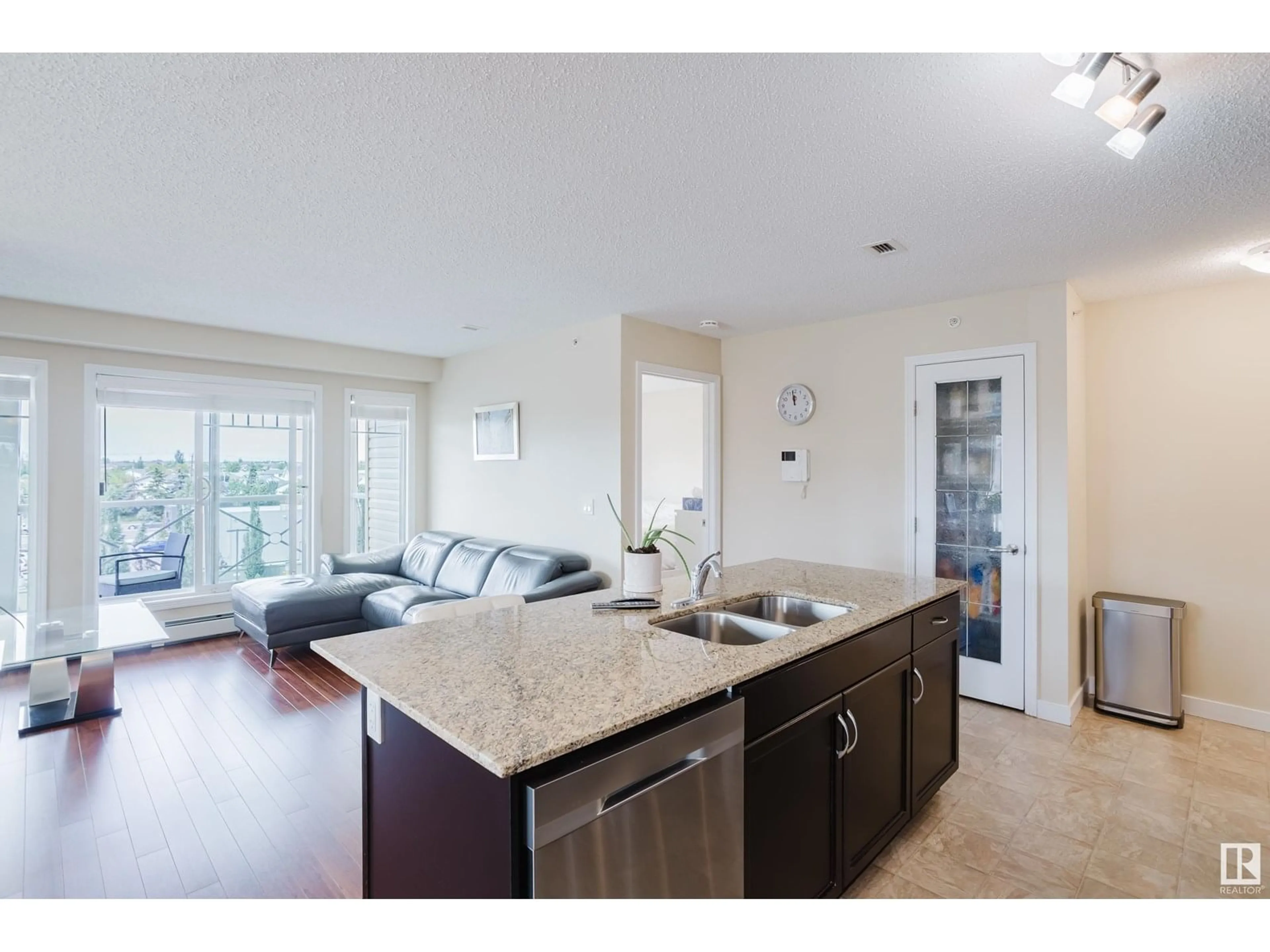 Open concept kitchen, wood/laminate floor for #415 - 12650 142 AV, Edmonton Alberta T5X0J4