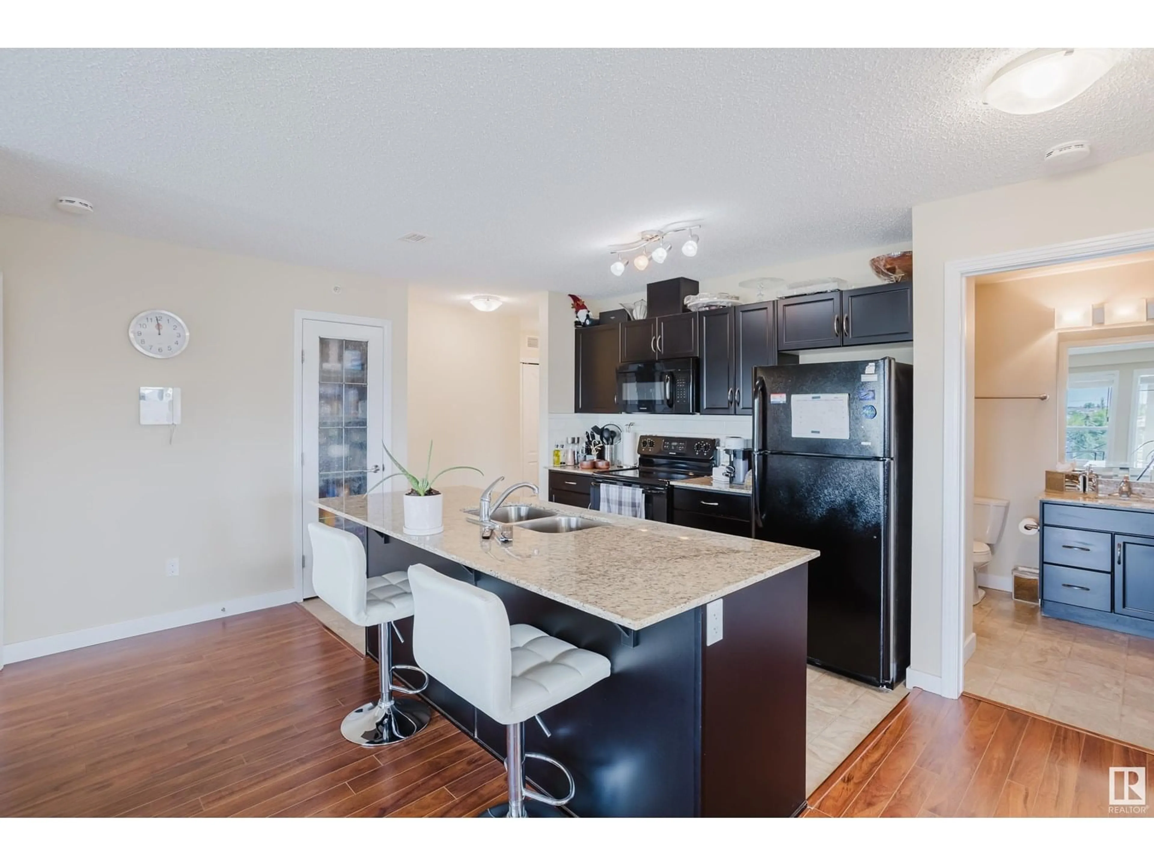 Open concept kitchen, wood/laminate floor for #415 - 12650 142 AV, Edmonton Alberta T5X0J4