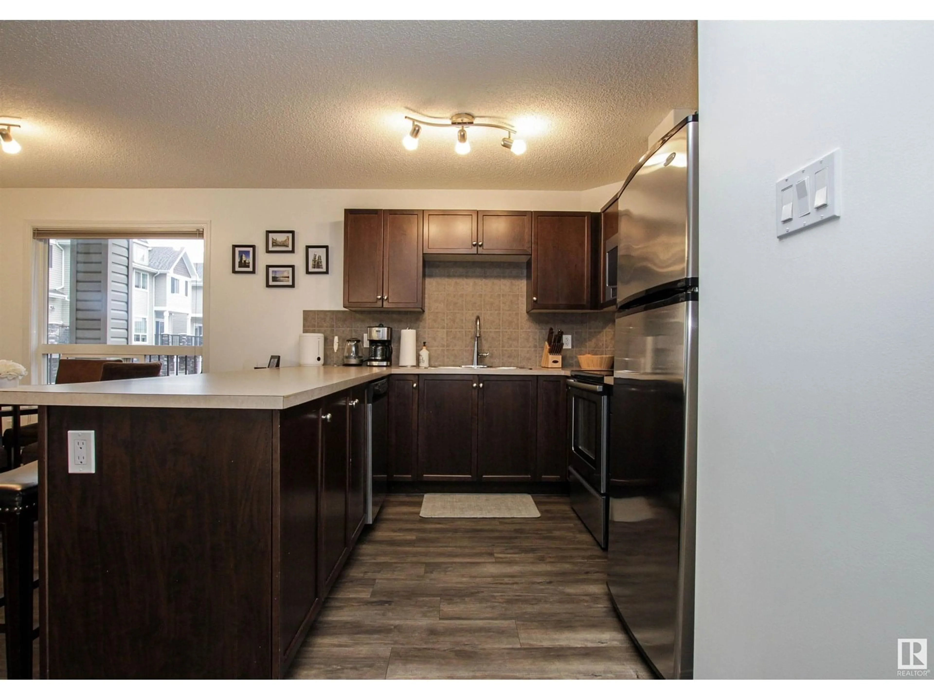 Open concept kitchen, wood/laminate floor for 7327 - 7208 SOUTH TERWILLEGAR DR, Edmonton Alberta T6R0L8