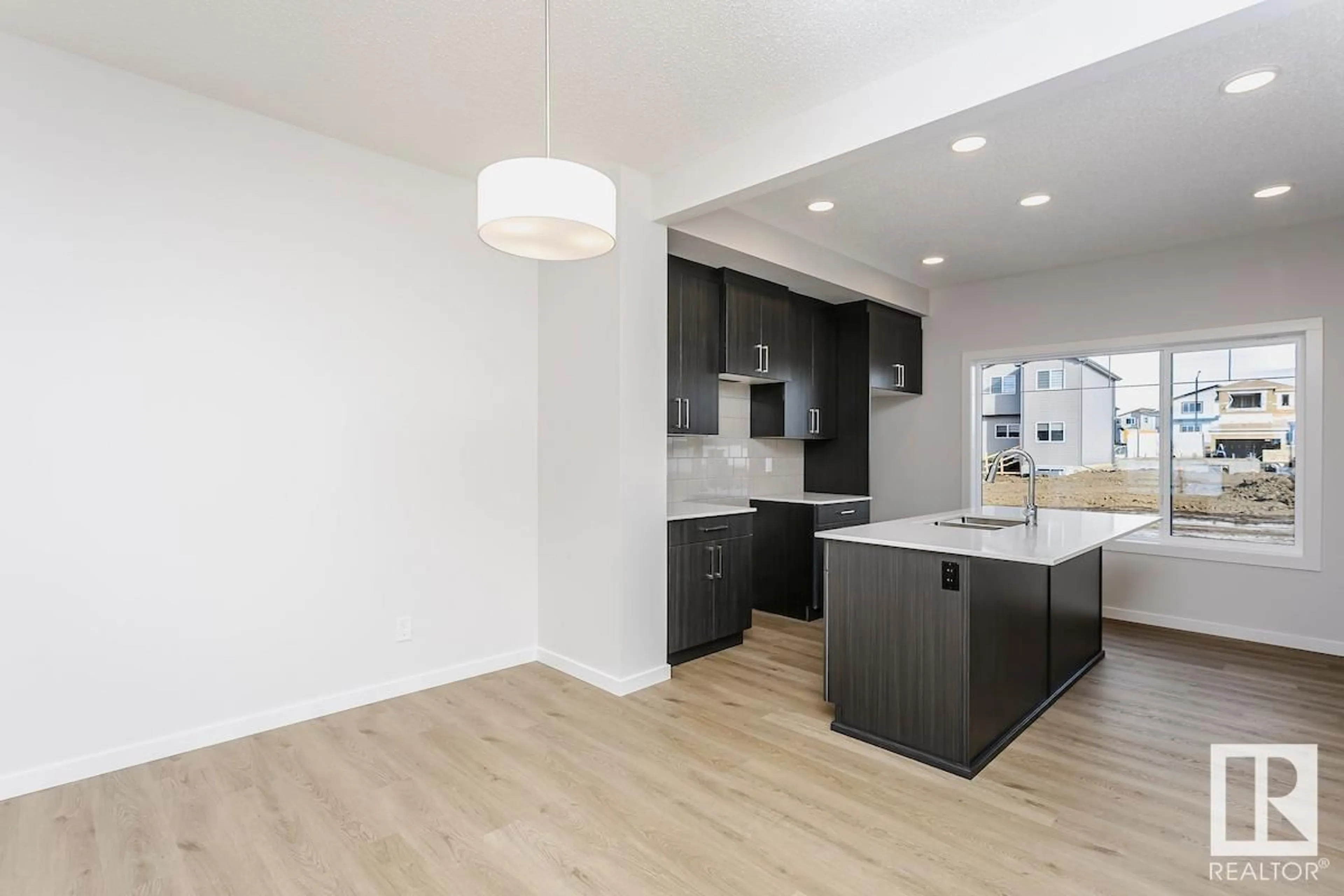 Open concept kitchen, wood/laminate floor for 310 HAWTHORN WY, Leduc Alberta T9E0B1