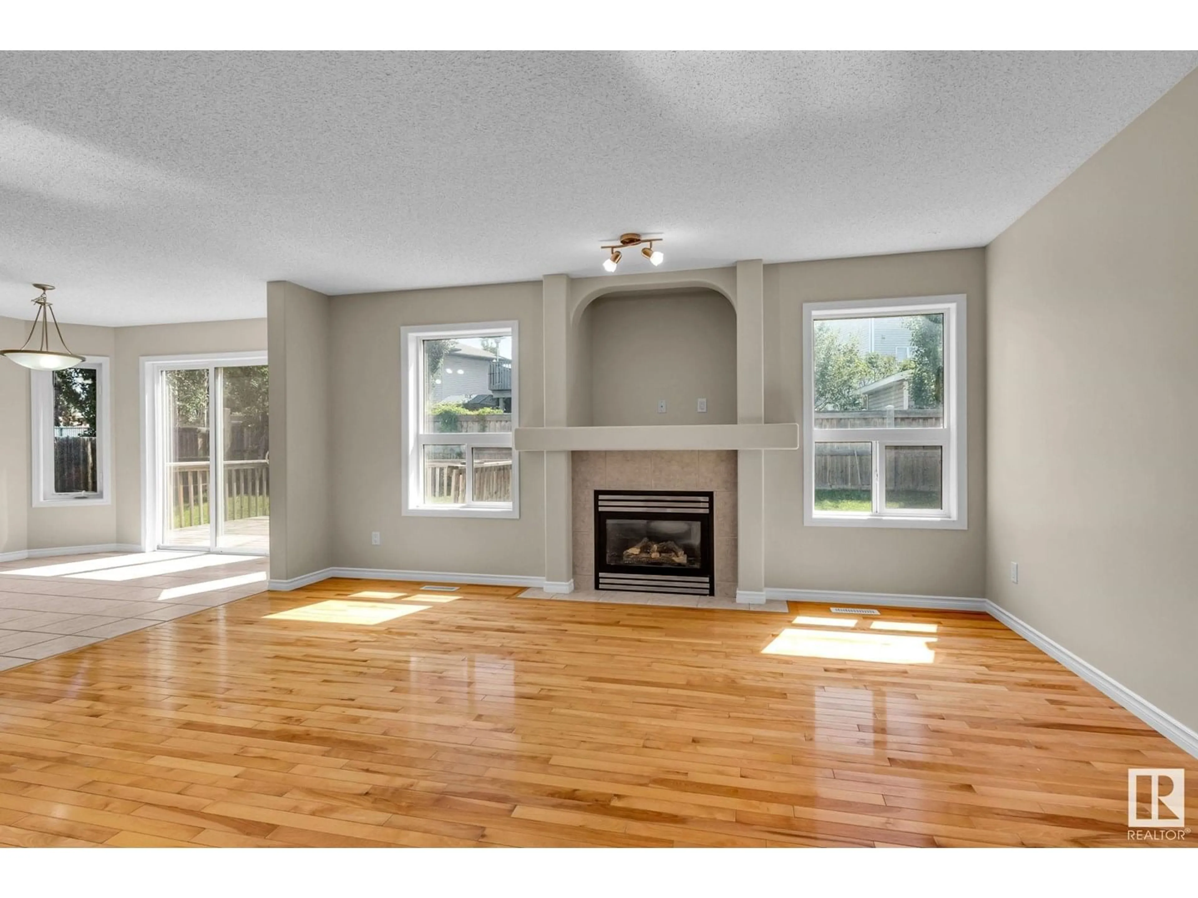 Living room with furniture, wood/laminate floor for 130 CHAMPLAIN PL, Beaumont Alberta T4X1V9