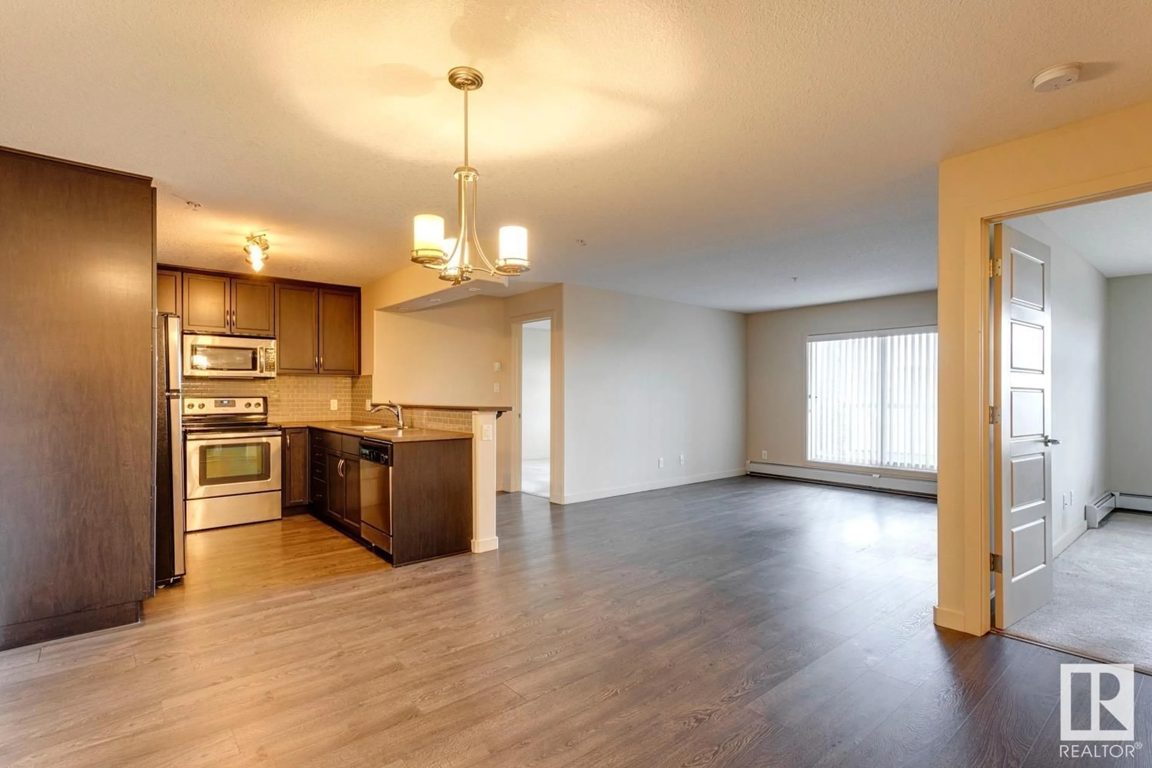 Open concept kitchen, wood/laminate floor for #254 - 11517 ELLERSLIE RD, Edmonton Alberta T6W2A9