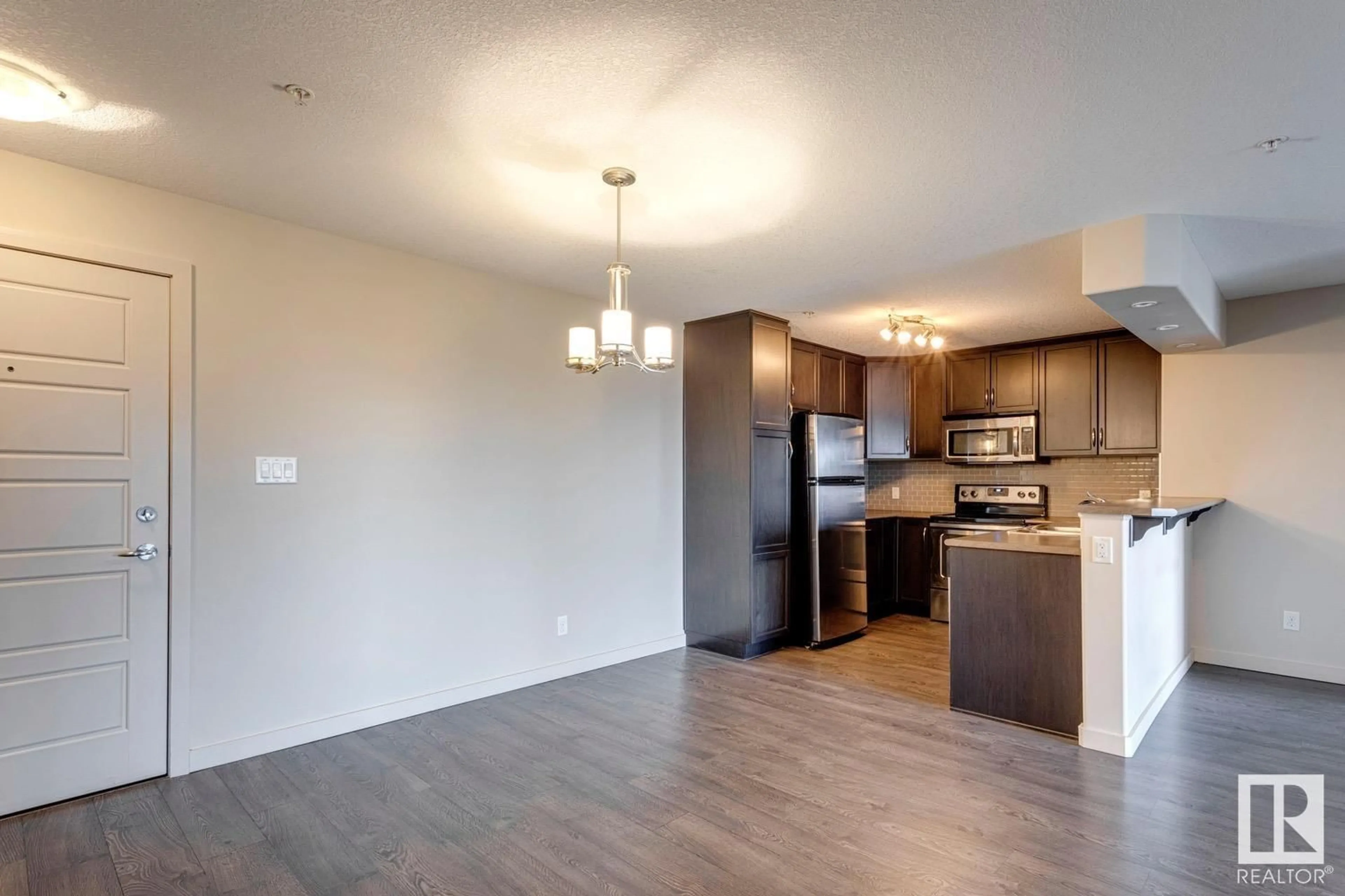 Open concept kitchen, wood/laminate floor for #254 - 11517 ELLERSLIE RD, Edmonton Alberta T6W2A9