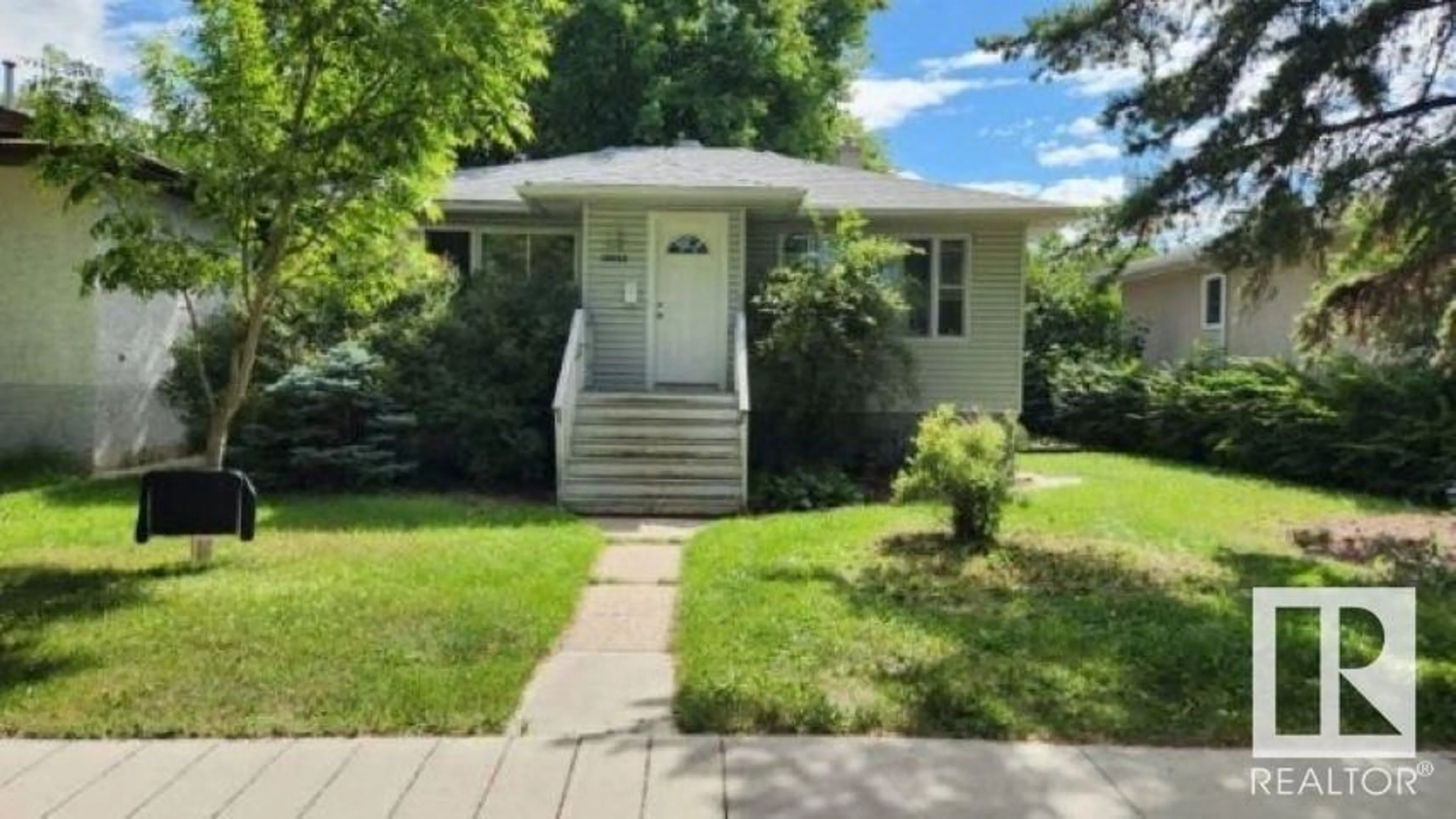 Home with vinyl exterior material, street for 10915 122 ST, Edmonton Alberta T5M0A7
