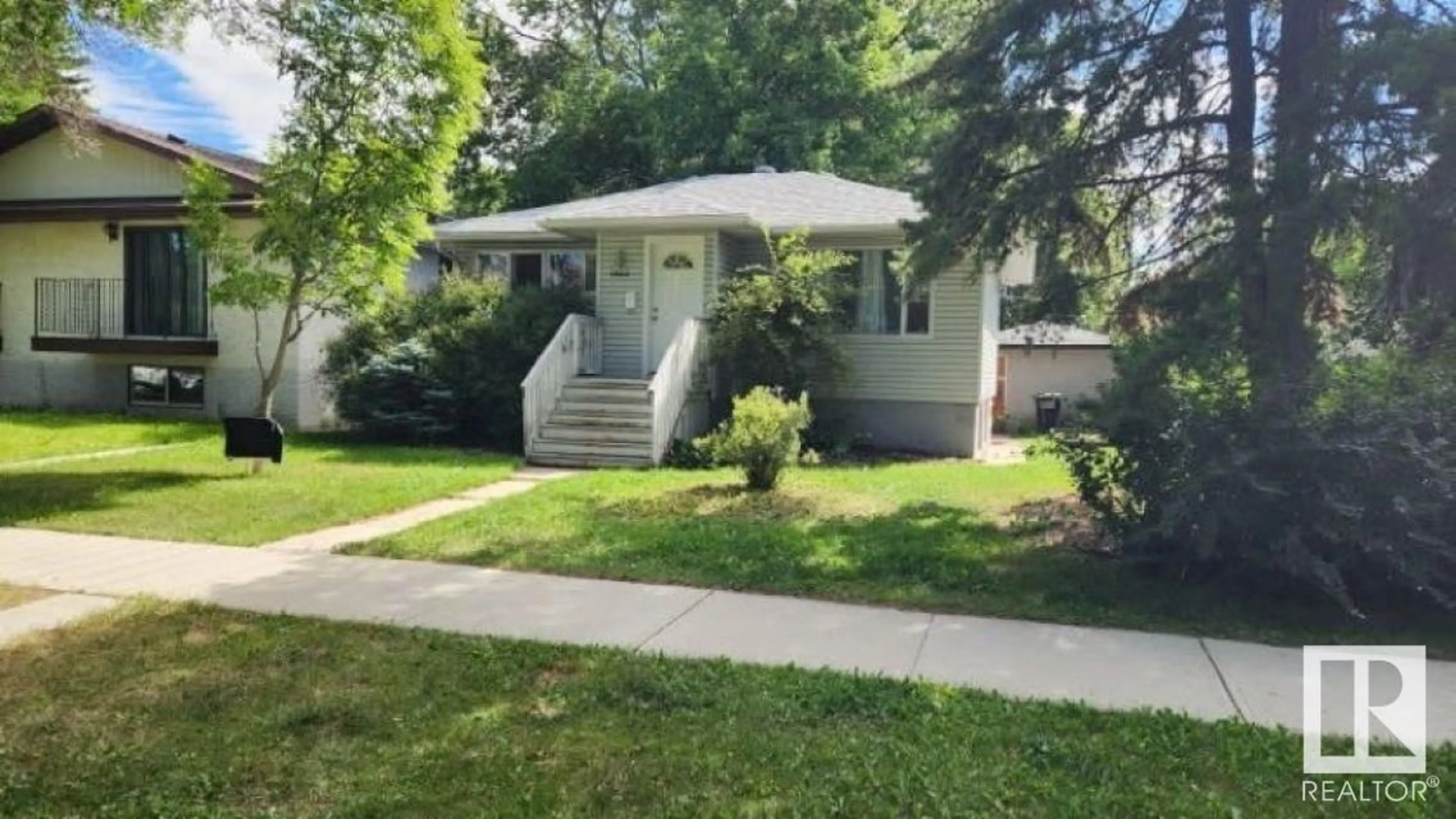 Home with vinyl exterior material, street for 10915 122 ST, Edmonton Alberta T5M0A7