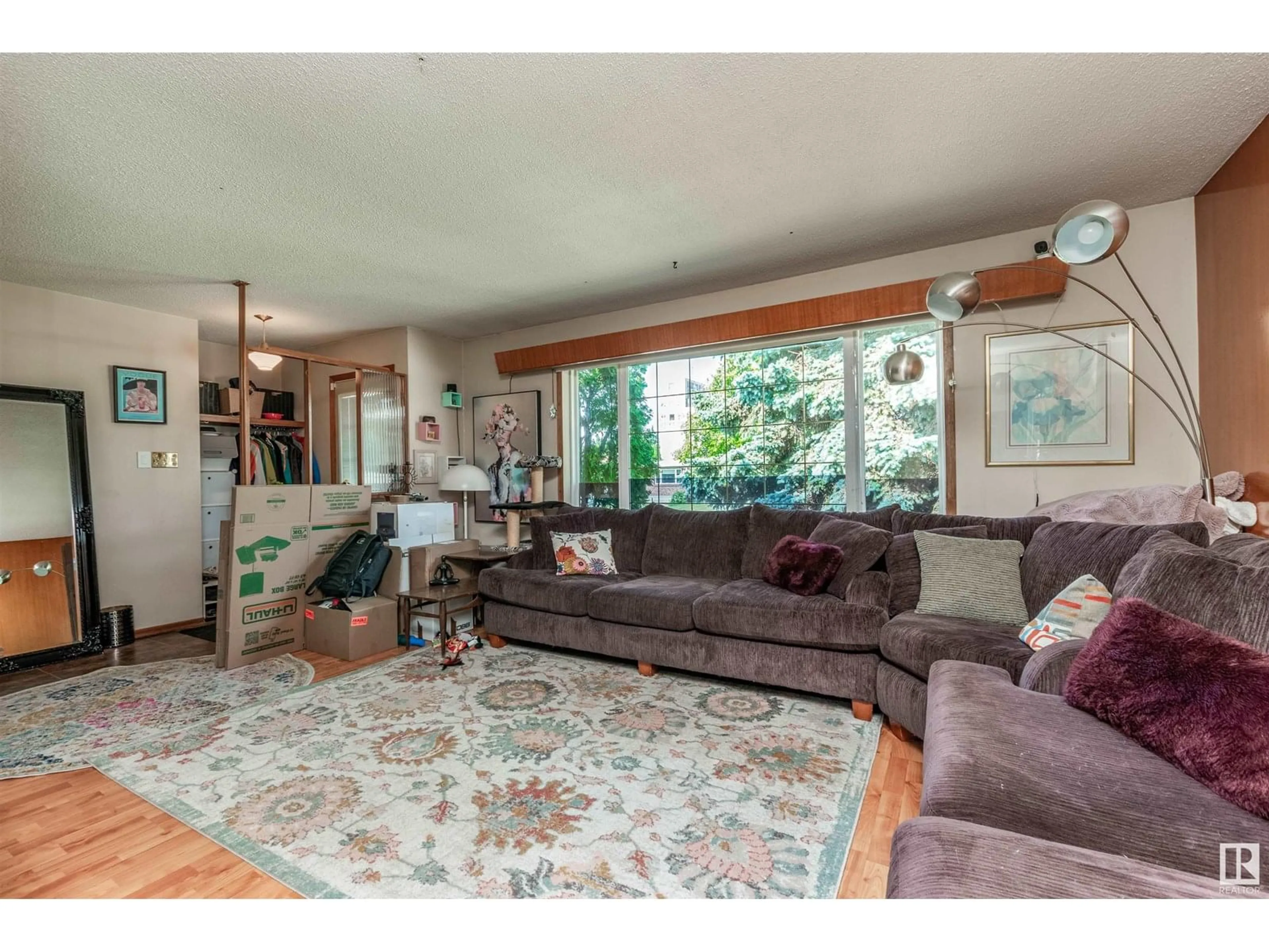 Living room with furniture, wood/laminate floor for NW - 12735 129 ST, Edmonton Alberta T5L1H9