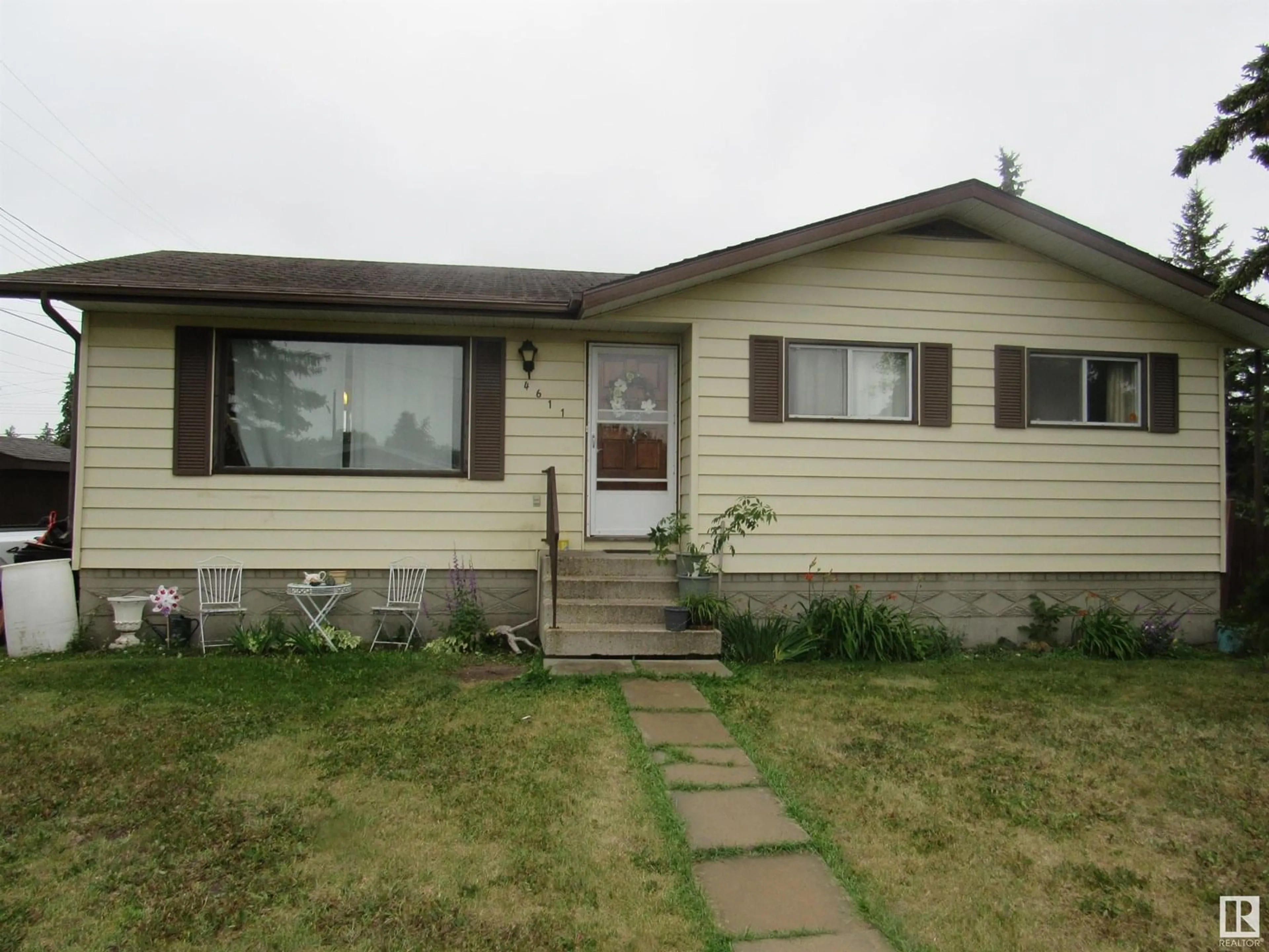 Home with vinyl exterior material, street for 4611 53 AVE, Barrhead Alberta T7N1H3