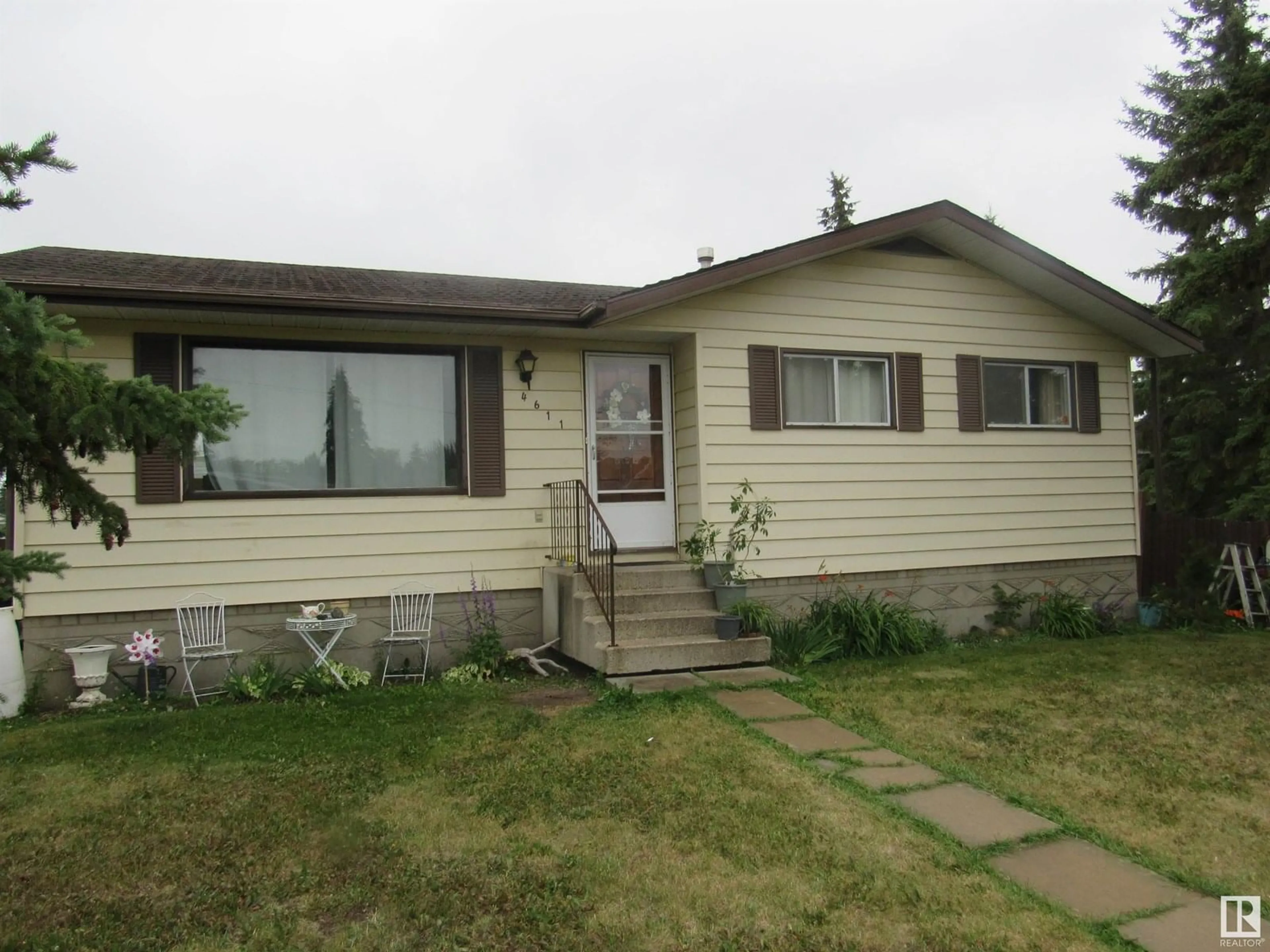 Home with vinyl exterior material, street for 4611 53 AVE, Barrhead Alberta T7N1H3