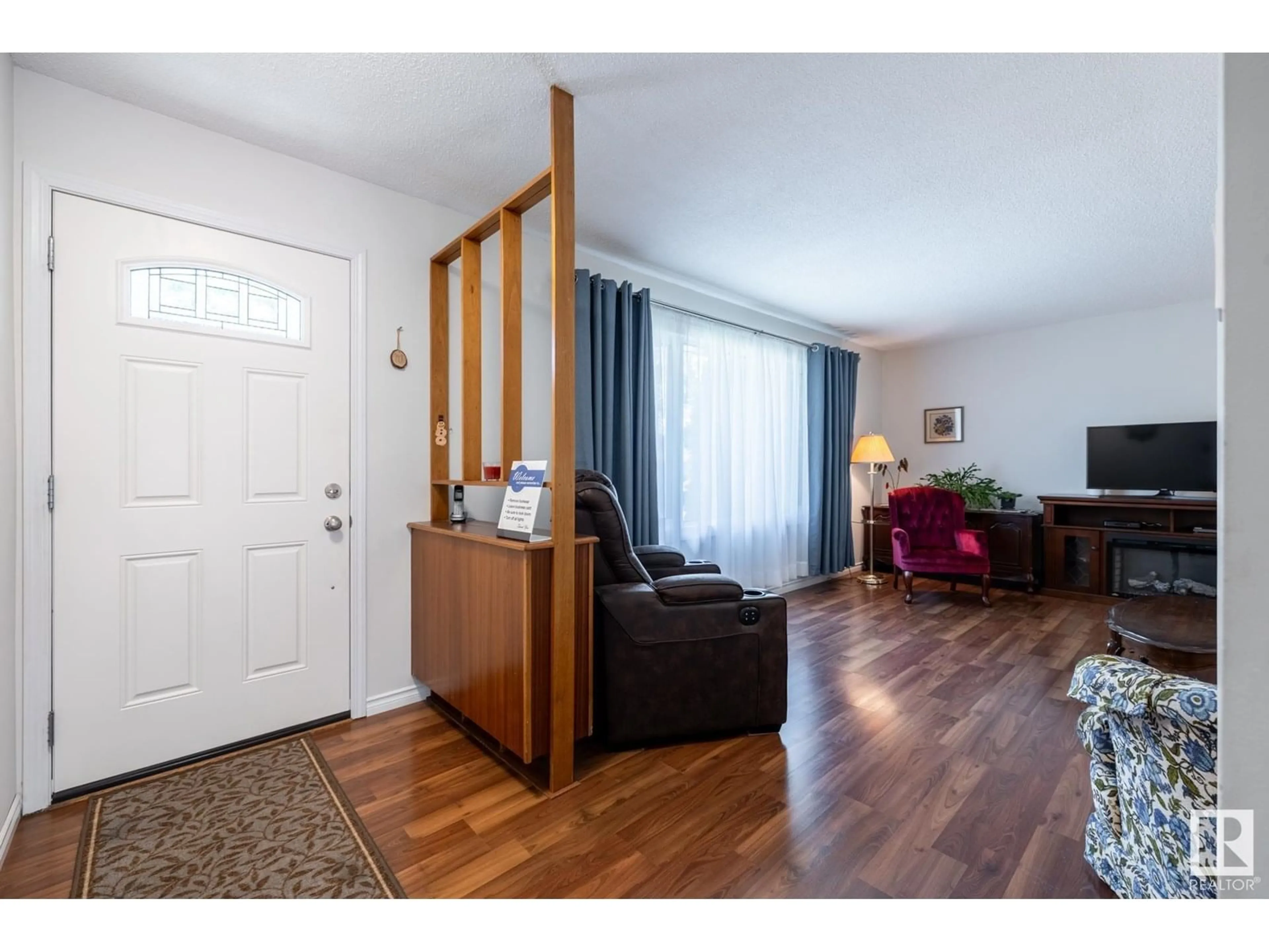 Living room with furniture, wood/laminate floor for NW - 15112 64 ST, Edmonton Alberta T5A2C5