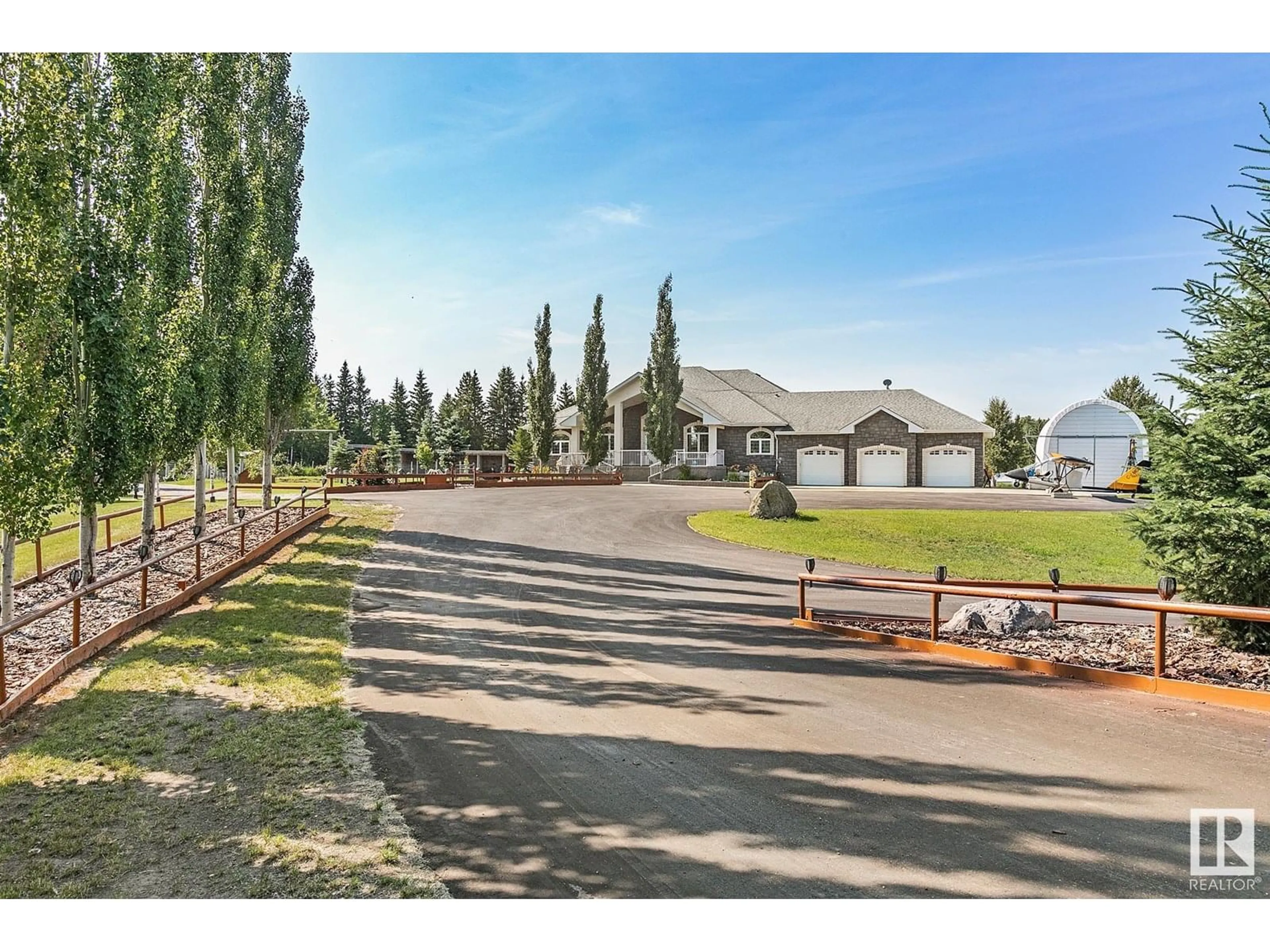 A pic from outside/outdoor area/front of a property/back of a property/a pic from drone, street for 400 - 51430 RGE ROAD 231, Rural Strathcona County Alberta T8B1K9