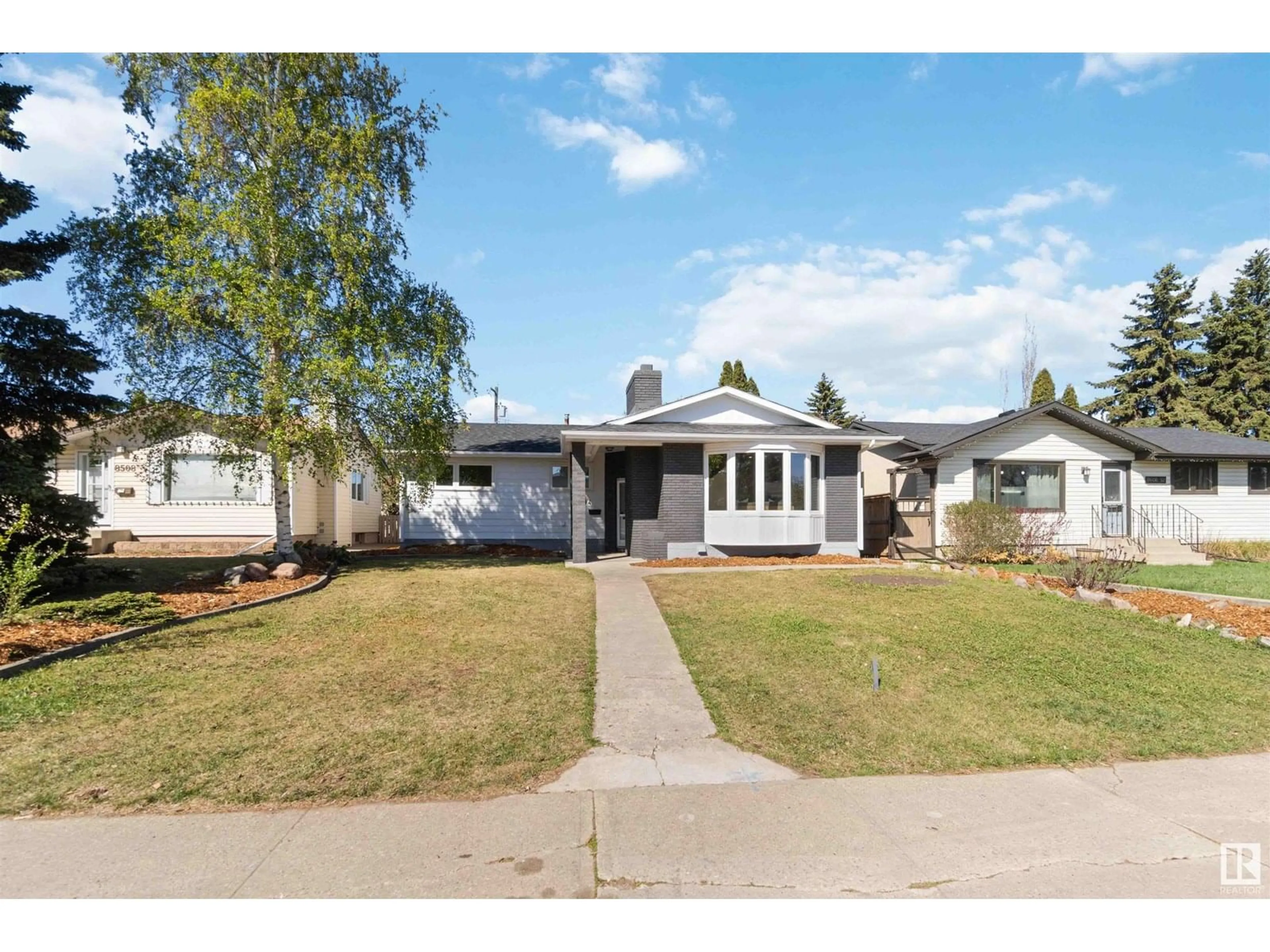 Home with vinyl exterior material, street for 8604 52 ST, Edmonton Alberta T6B1E9