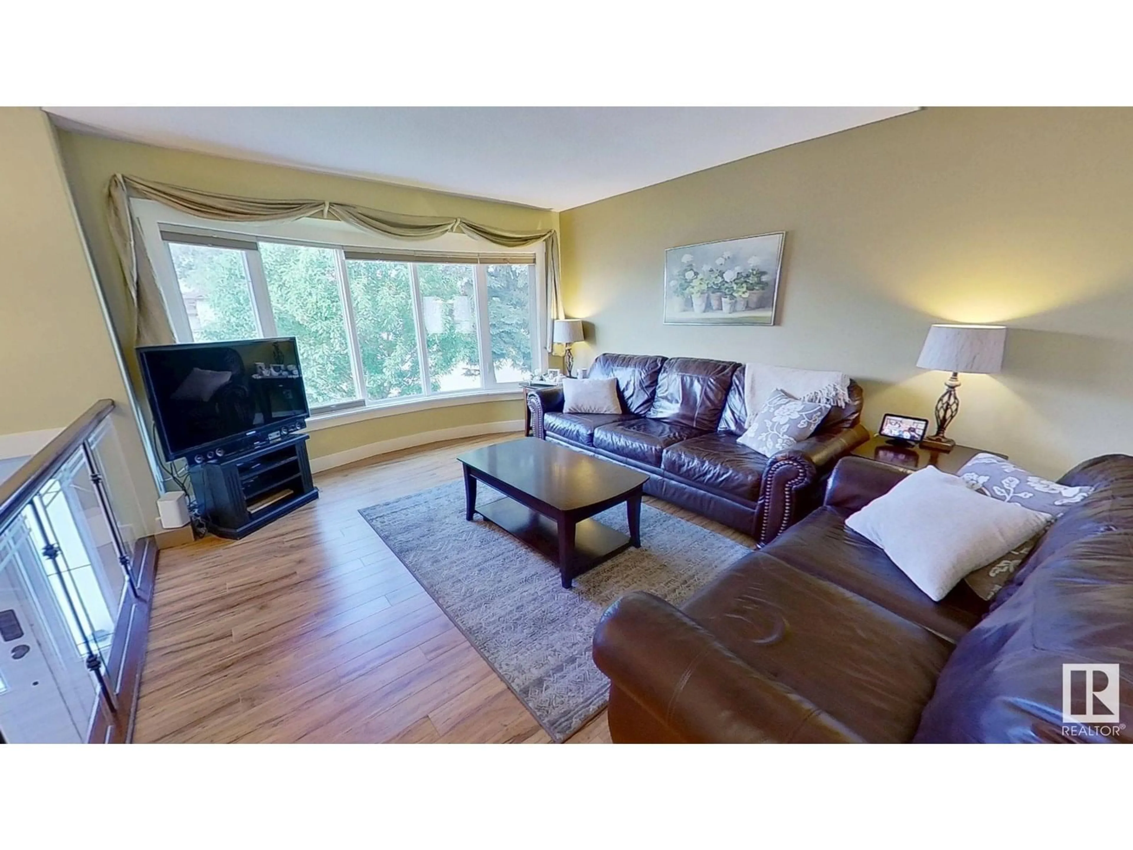 Living room with furniture, wood/laminate floor for 4024 19 AV, Edmonton Alberta T6L3M7