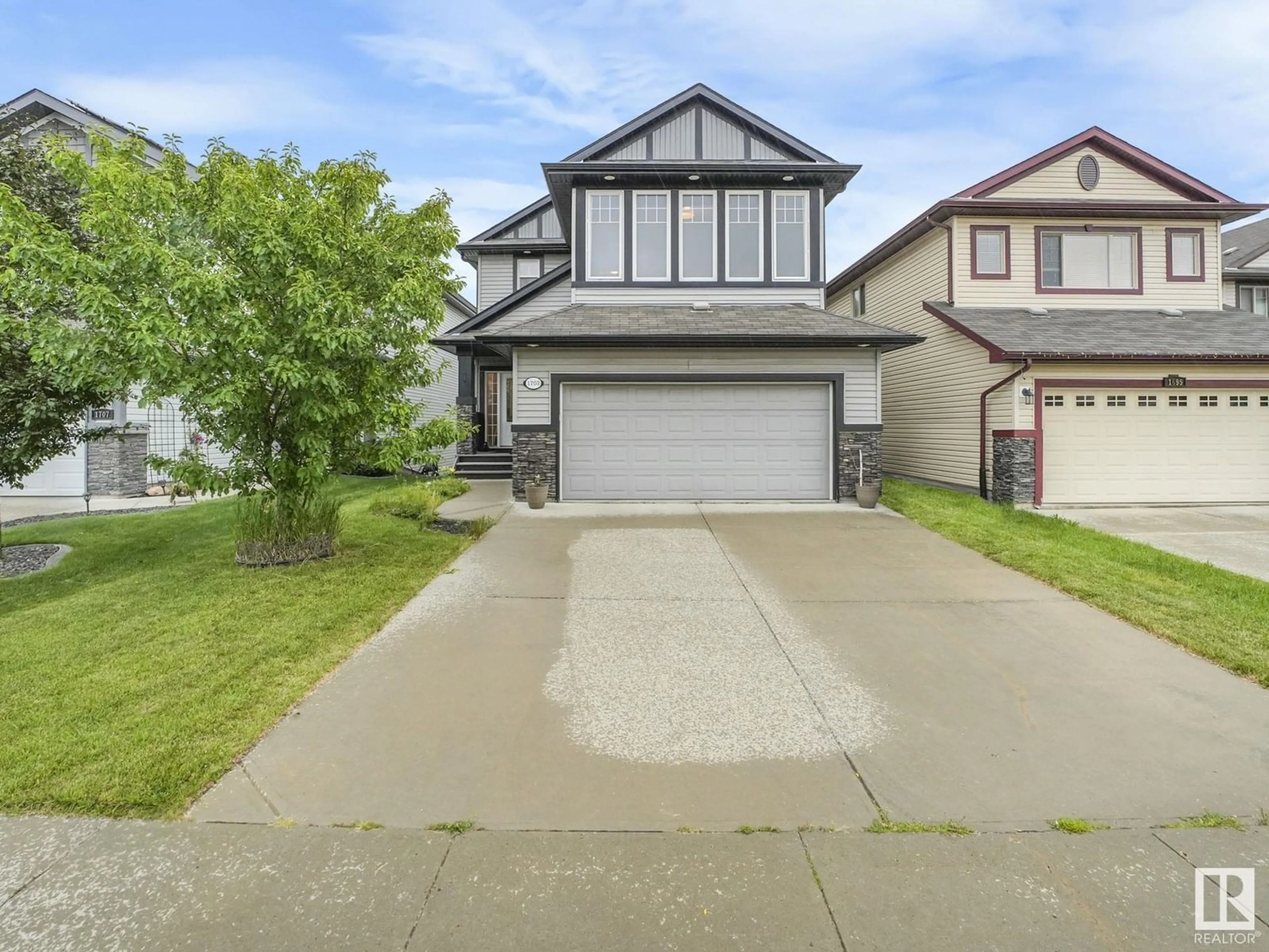 Home with vinyl exterior material, street for NW - 1703 33B ST, Edmonton Alberta T6T0P2