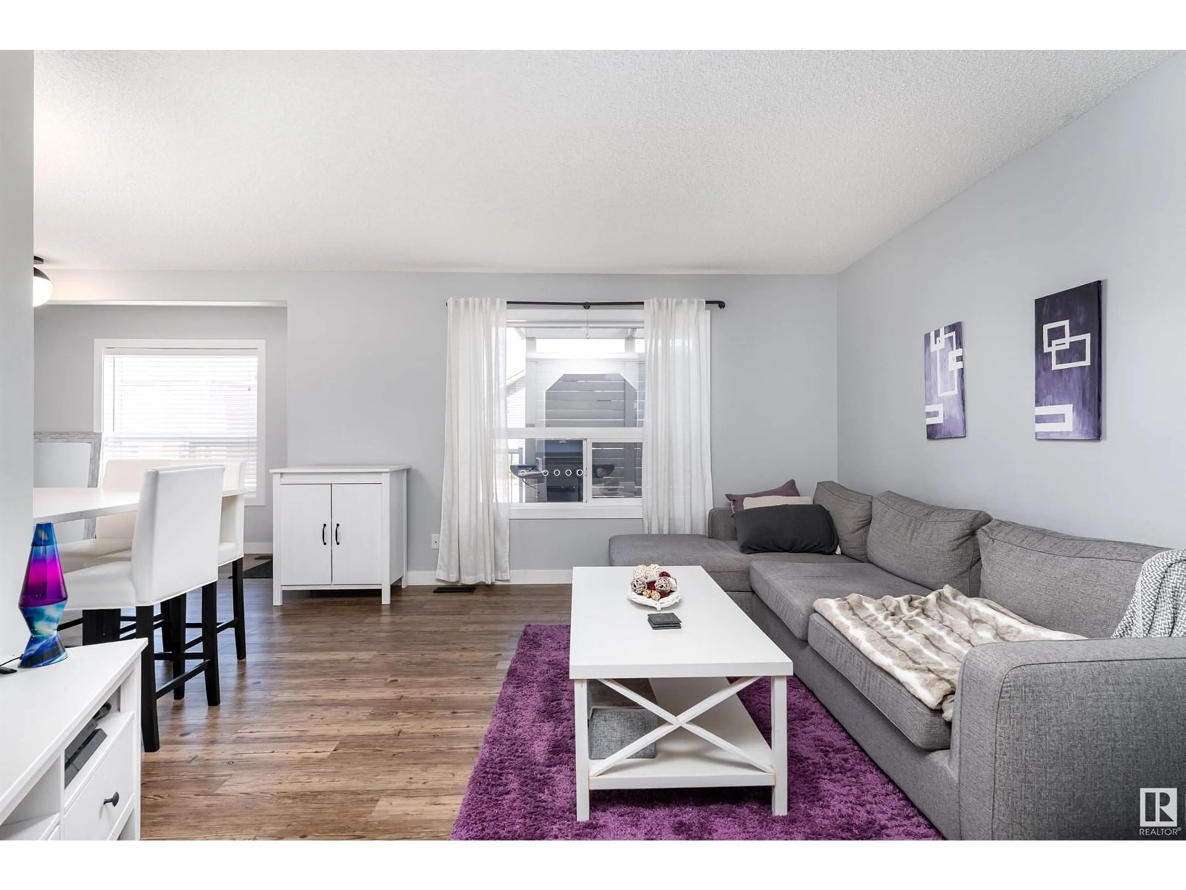 Living room with furniture, wood/laminate floor for 212 ASCOTT CR, Sherwood Park Alberta T8H0A6