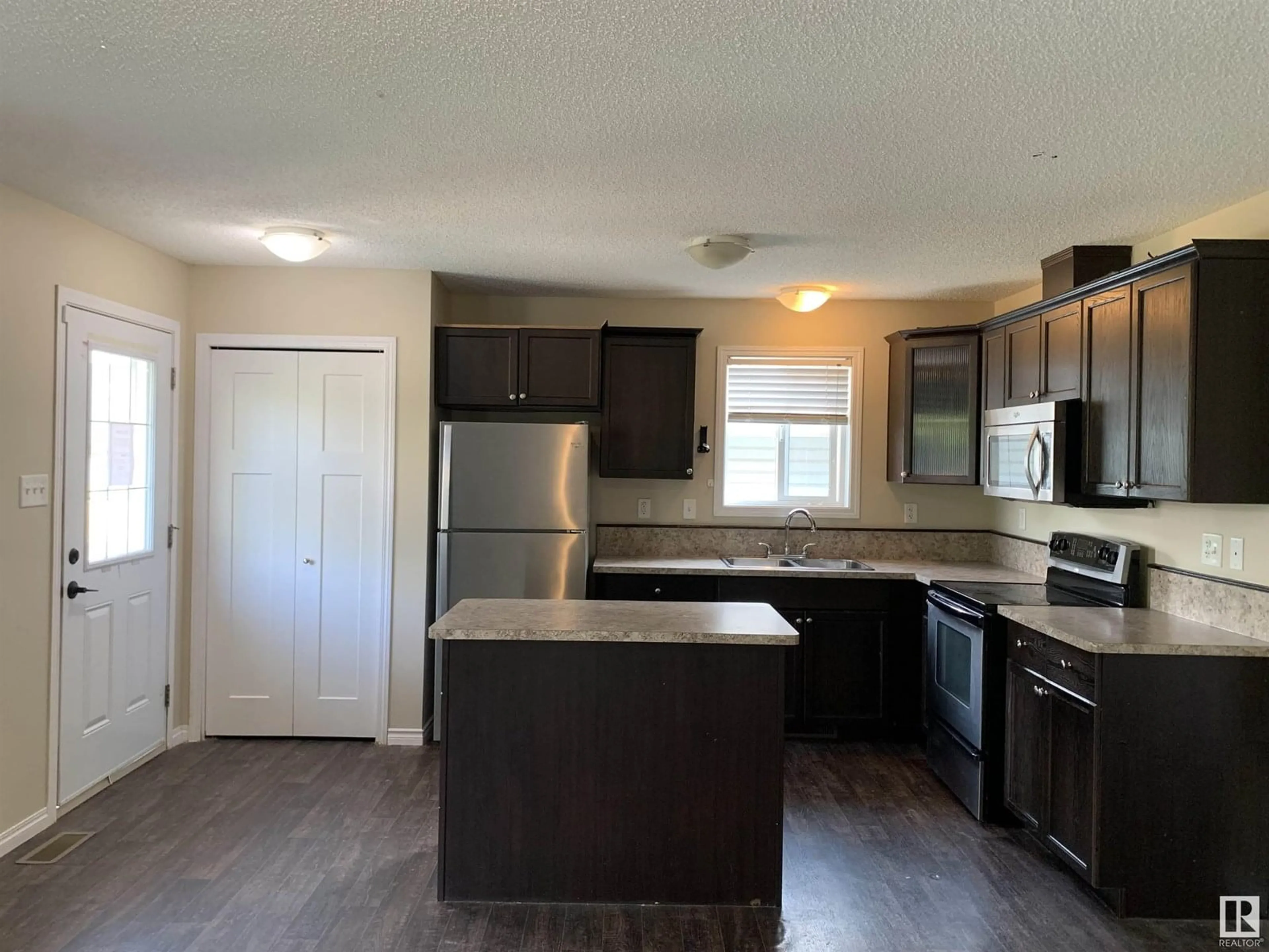Open concept kitchen, wood/laminate floor for NW - 11824 93 ST, Edmonton Alberta T5G1E3