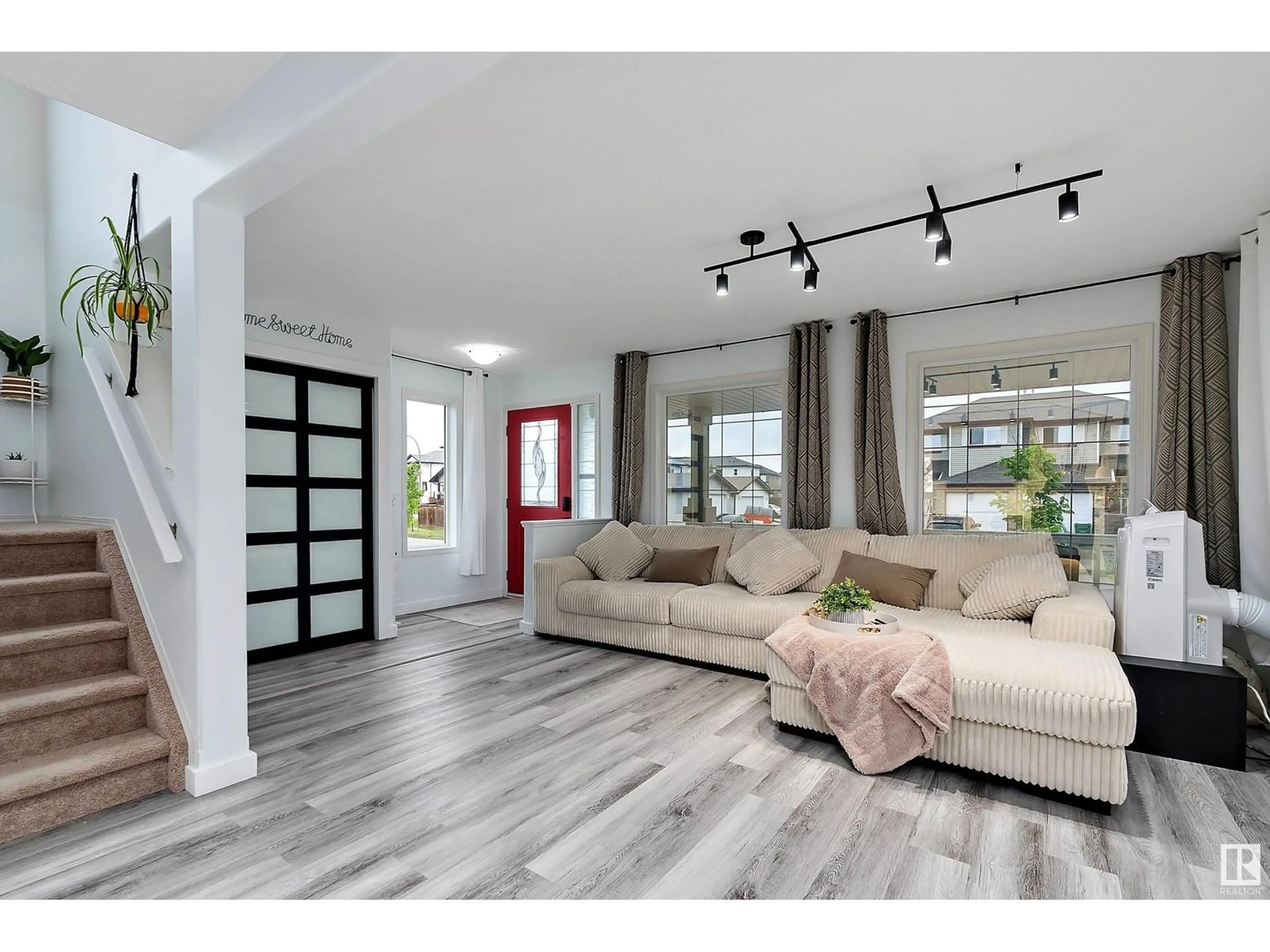 Living room with furniture, wood/laminate floor for 130 DOUGLAS LN, Leduc Alberta T9E0J7