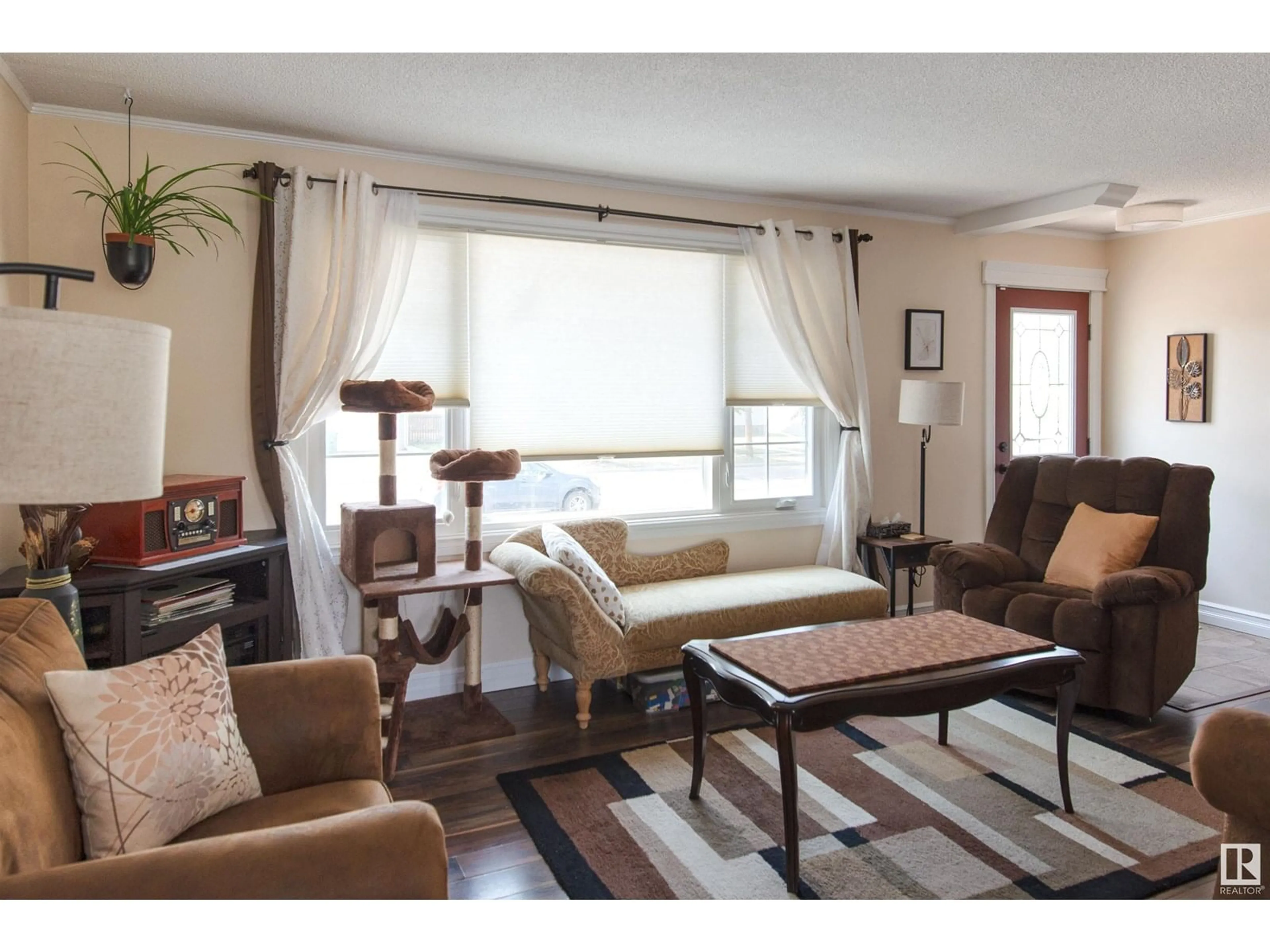 Living room with furniture, wood/laminate floor for 4729 45 AV, Bonnyville Town Alberta T9N1M7