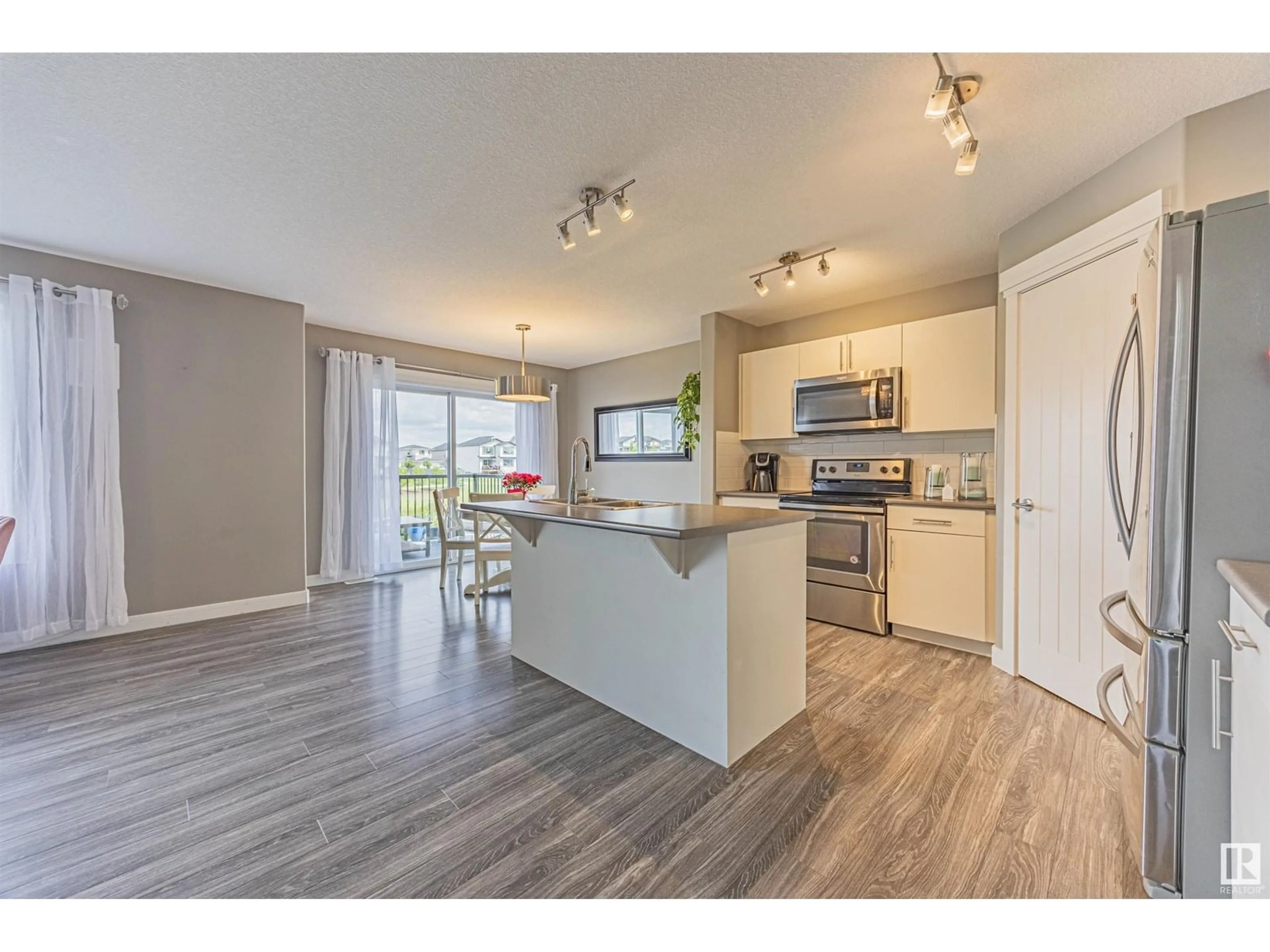Open concept kitchen, wood/laminate floor for 6406 61 AV, Beaumont Alberta T4X1Z2