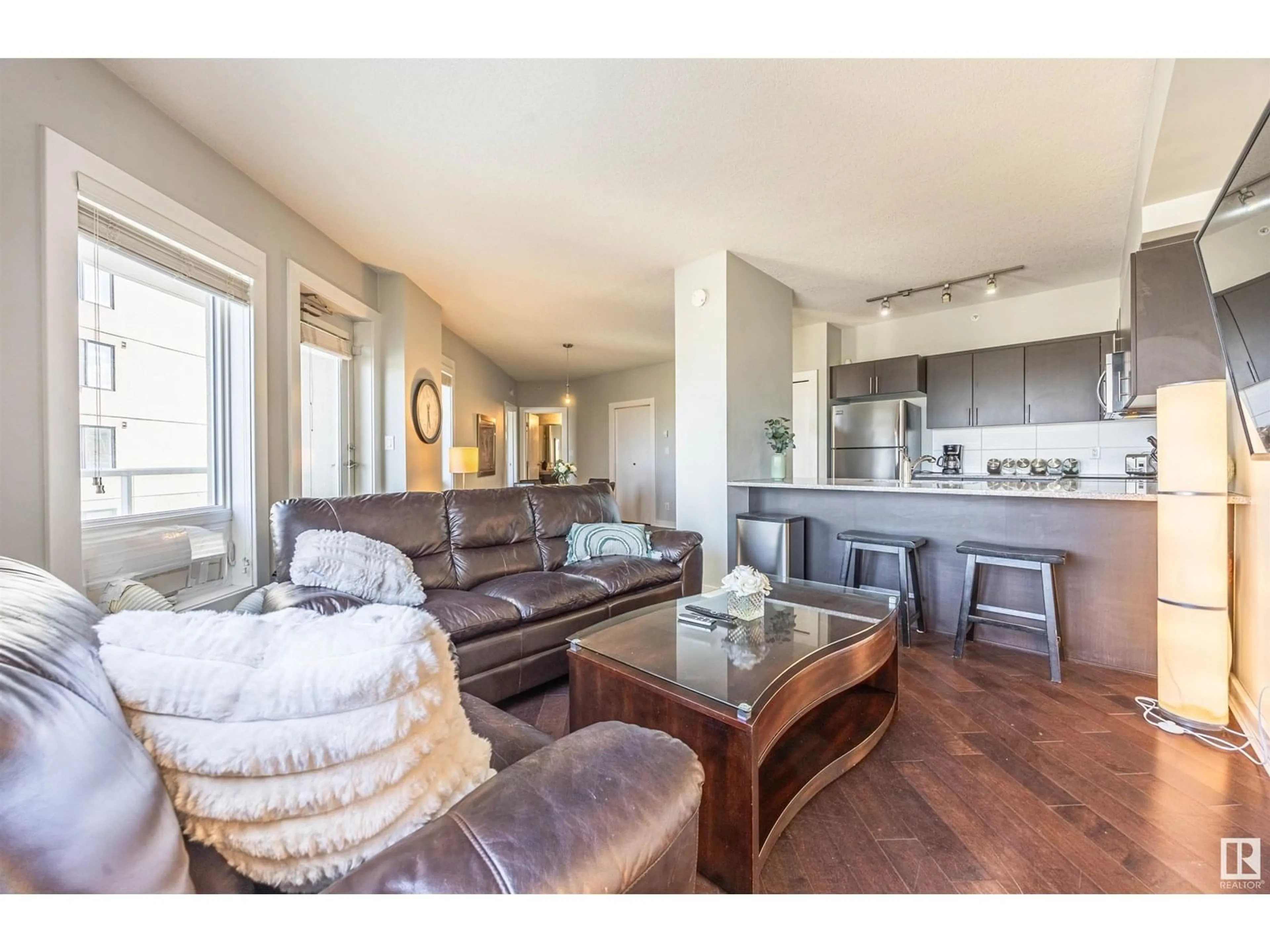 Living room with furniture, wood/laminate floor for 1201 104 ST NW, Edmonton Alberta T5J0B6