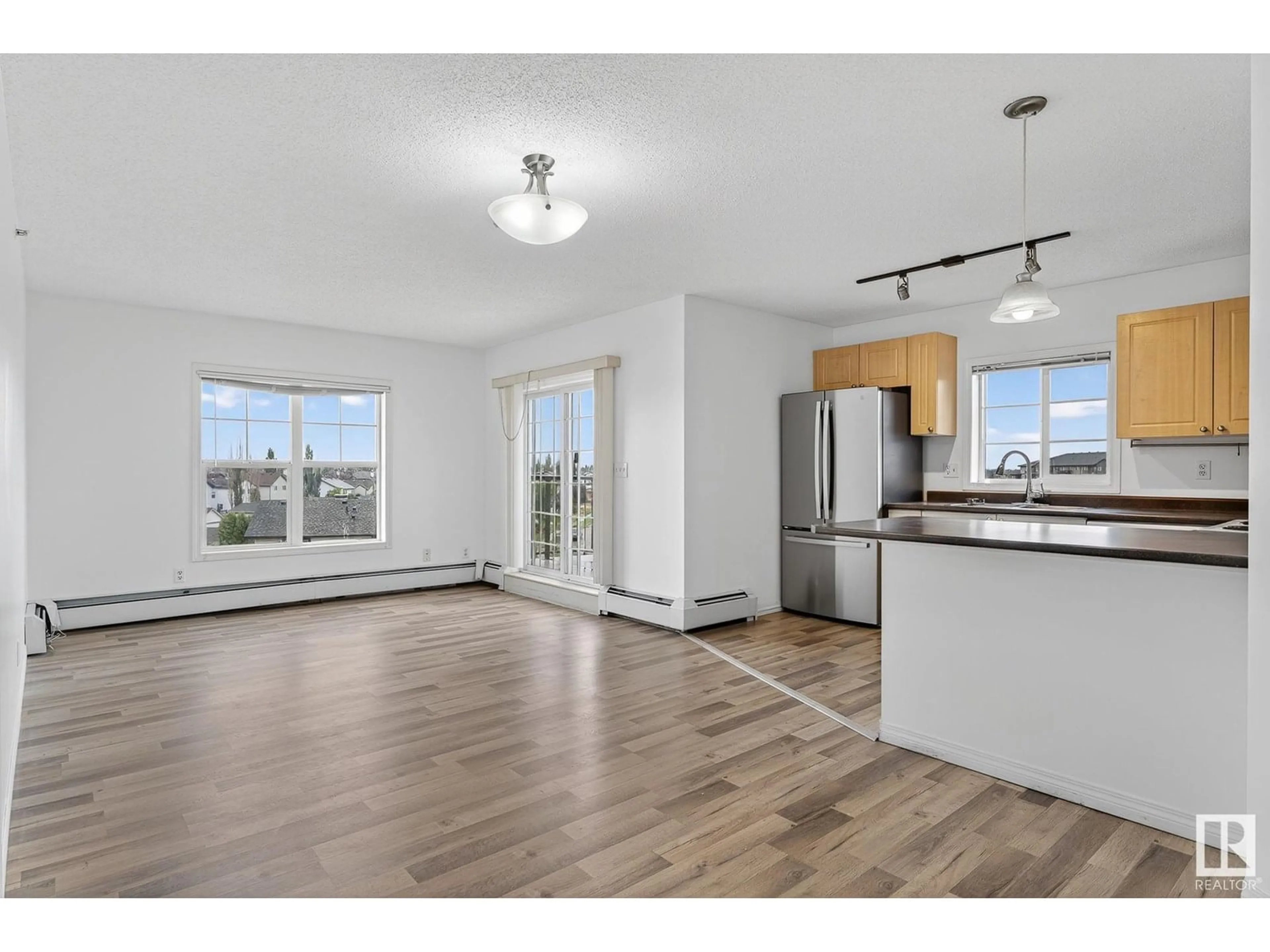 Open concept kitchen, wood/laminate floor for 622 - 418 MCALLISTER LO, Edmonton Alberta T6W1N2