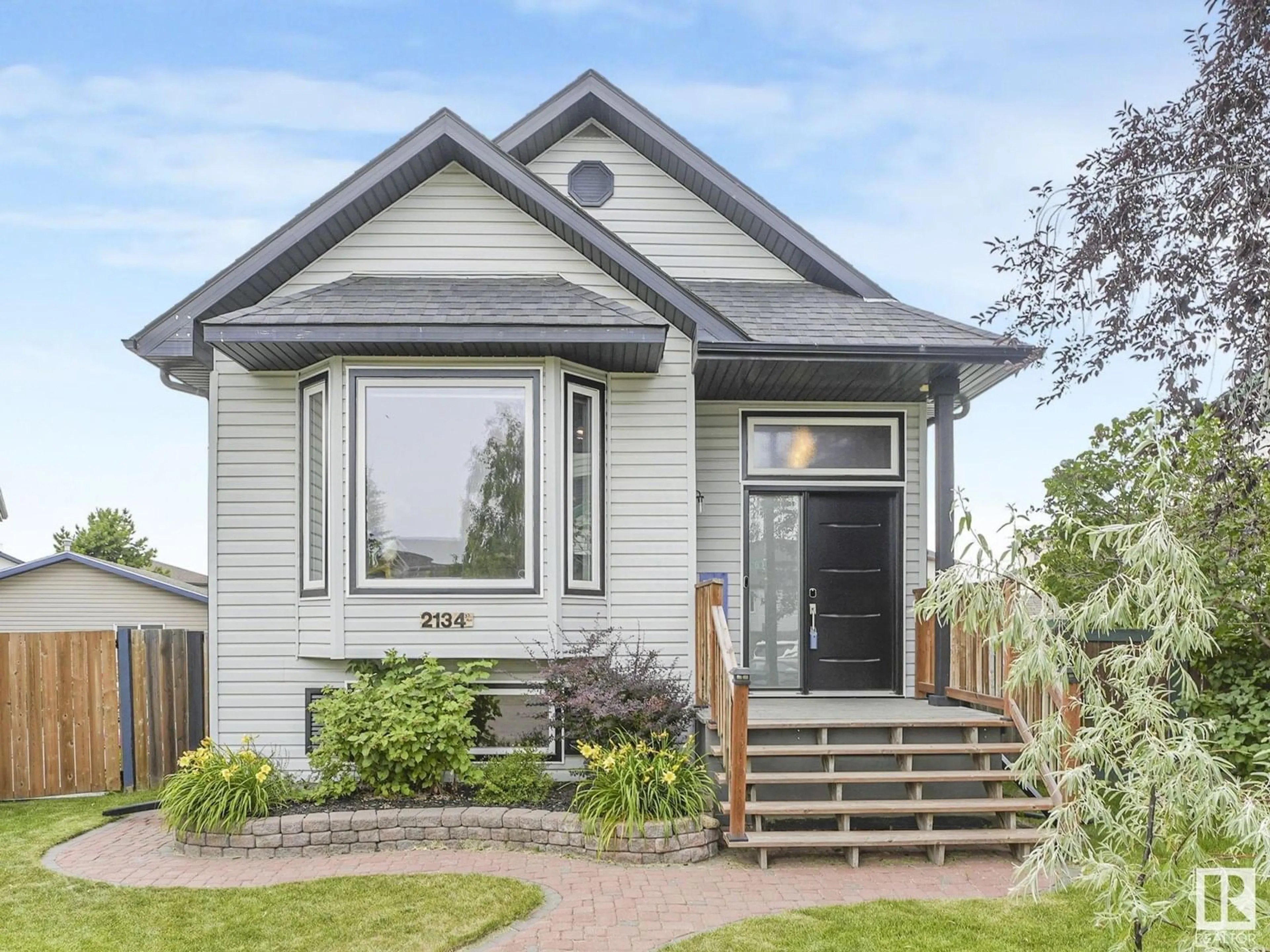 Home with vinyl exterior material, street for NW - 2134 37 AV, Edmonton Alberta T6T1S2