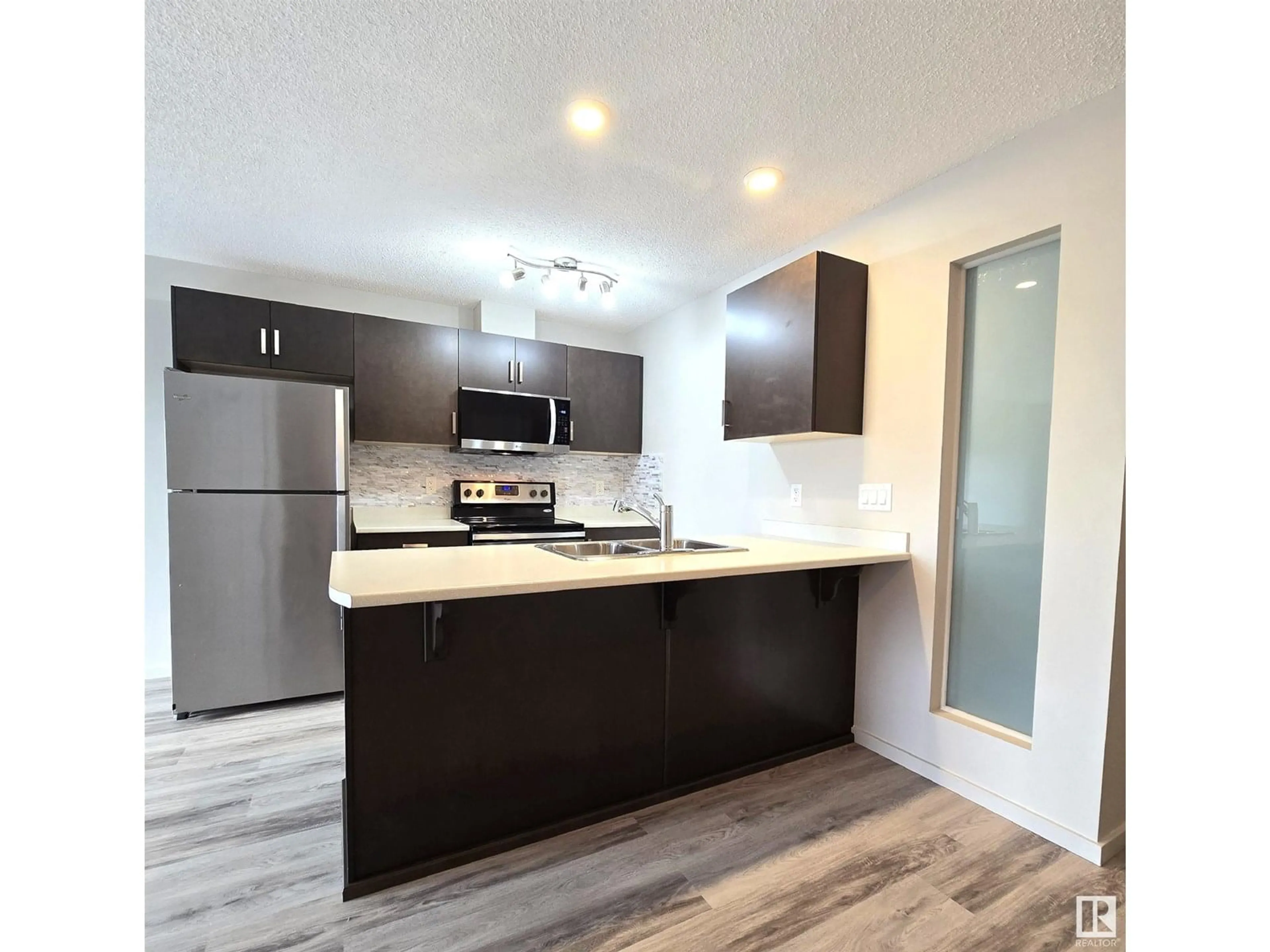 Open concept kitchen, wood/laminate floor for 390 - 434 WINDERMERE RD, Edmonton Alberta T6W0R1