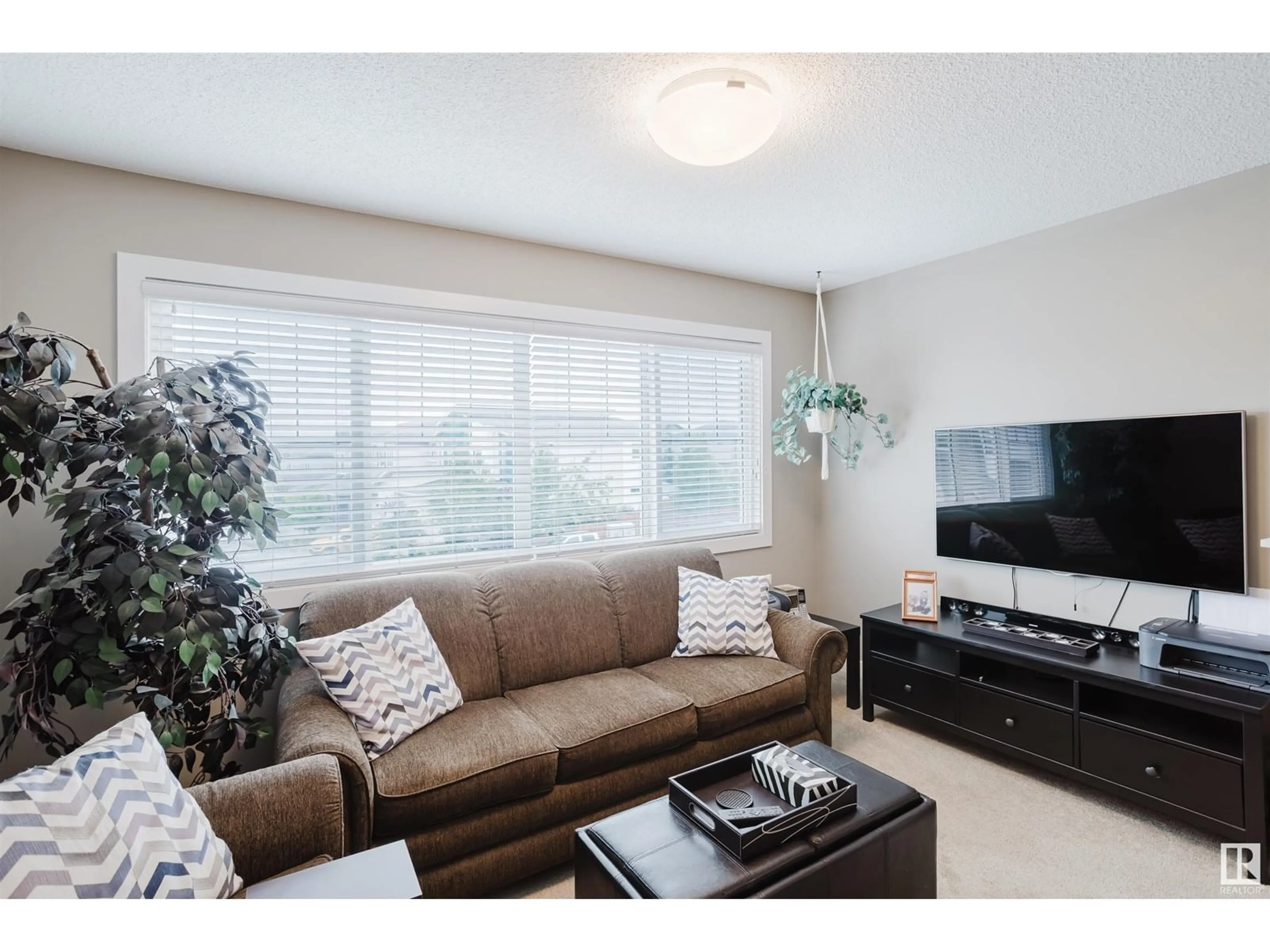 Living room with furniture, wood/laminate floor for 4724 67 ST, Beaumont Alberta T4X1Y5