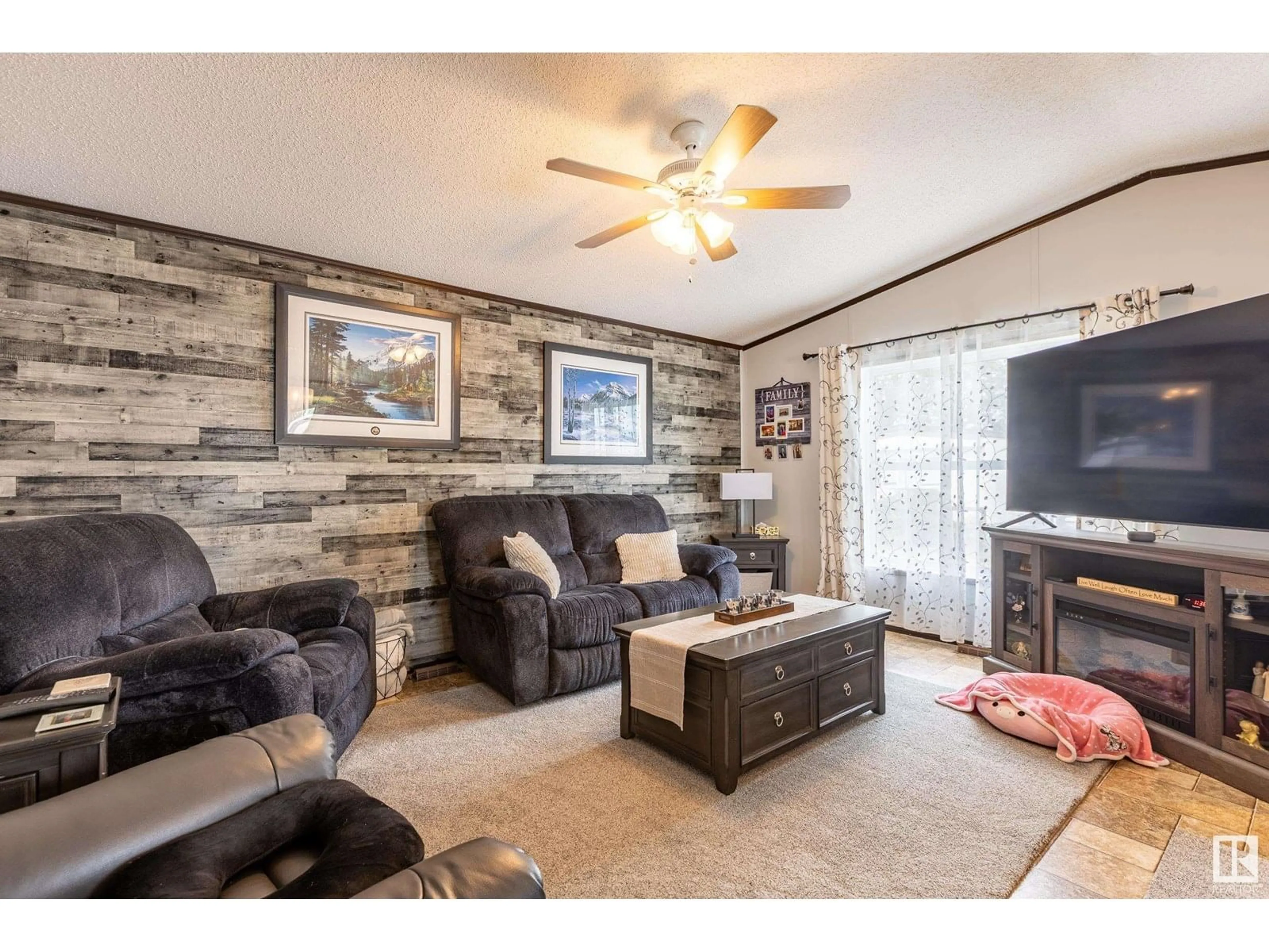 Living room with furniture, wood/laminate floor for 61 - 10410 101A ST, Morinville Alberta T8R1B2