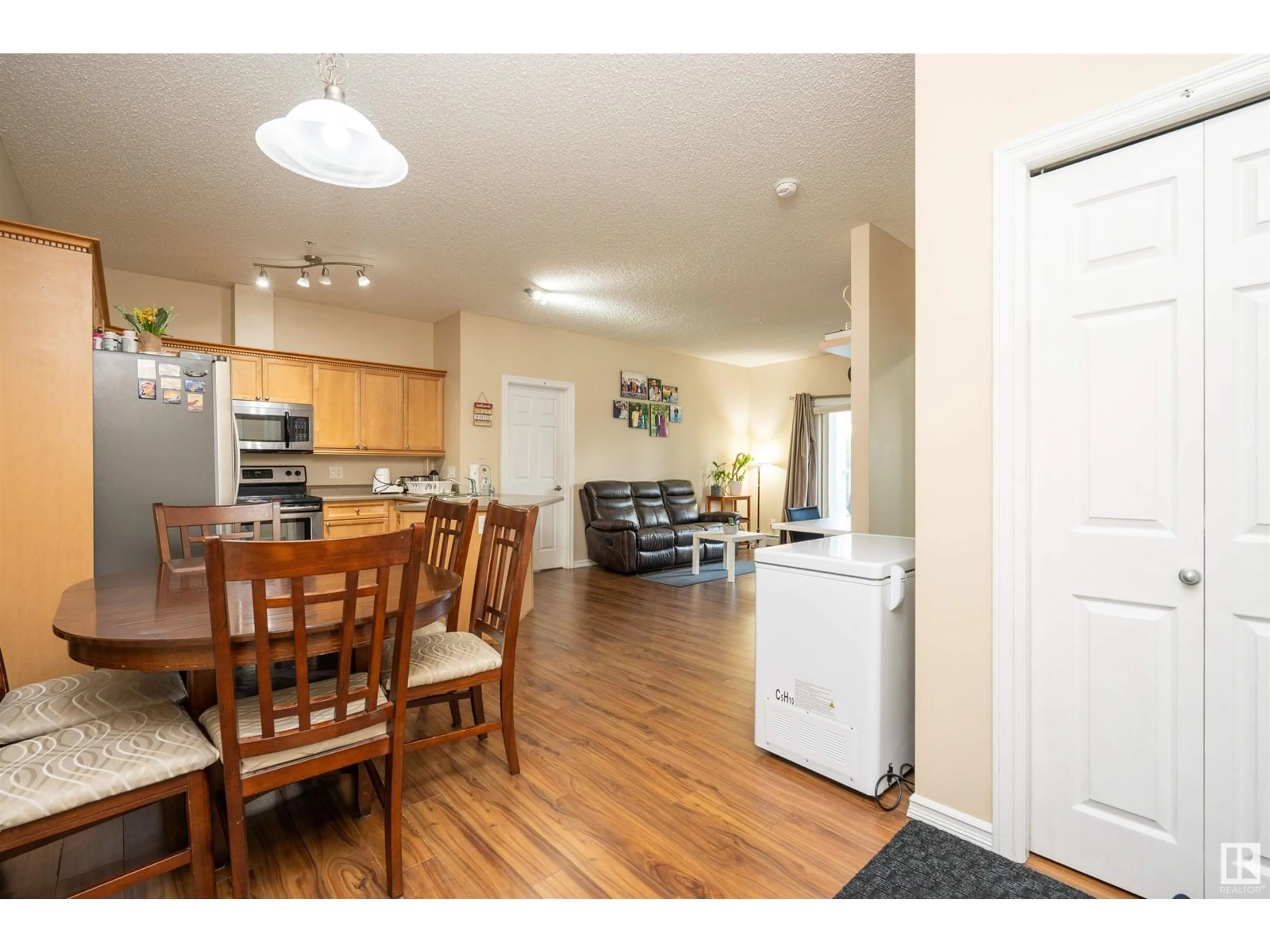 Open concept kitchen, wood/laminate floor for 226 - 117 MACEWAN ROAD SW, Edmonton Alberta T6W0C5
