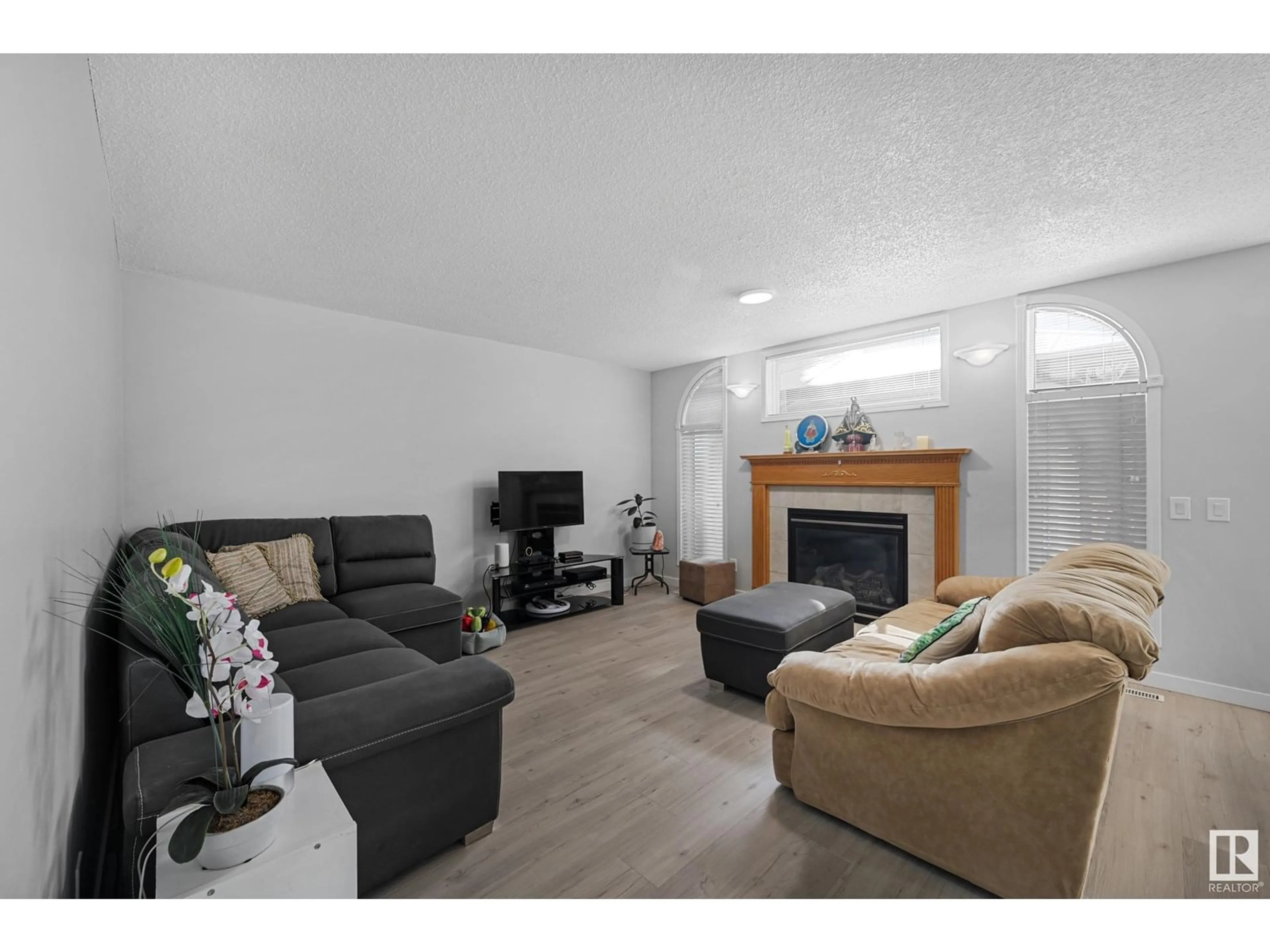 Living room with furniture, wood/laminate floor for NW - 4960 191 ST, Edmonton Alberta T6M2T8