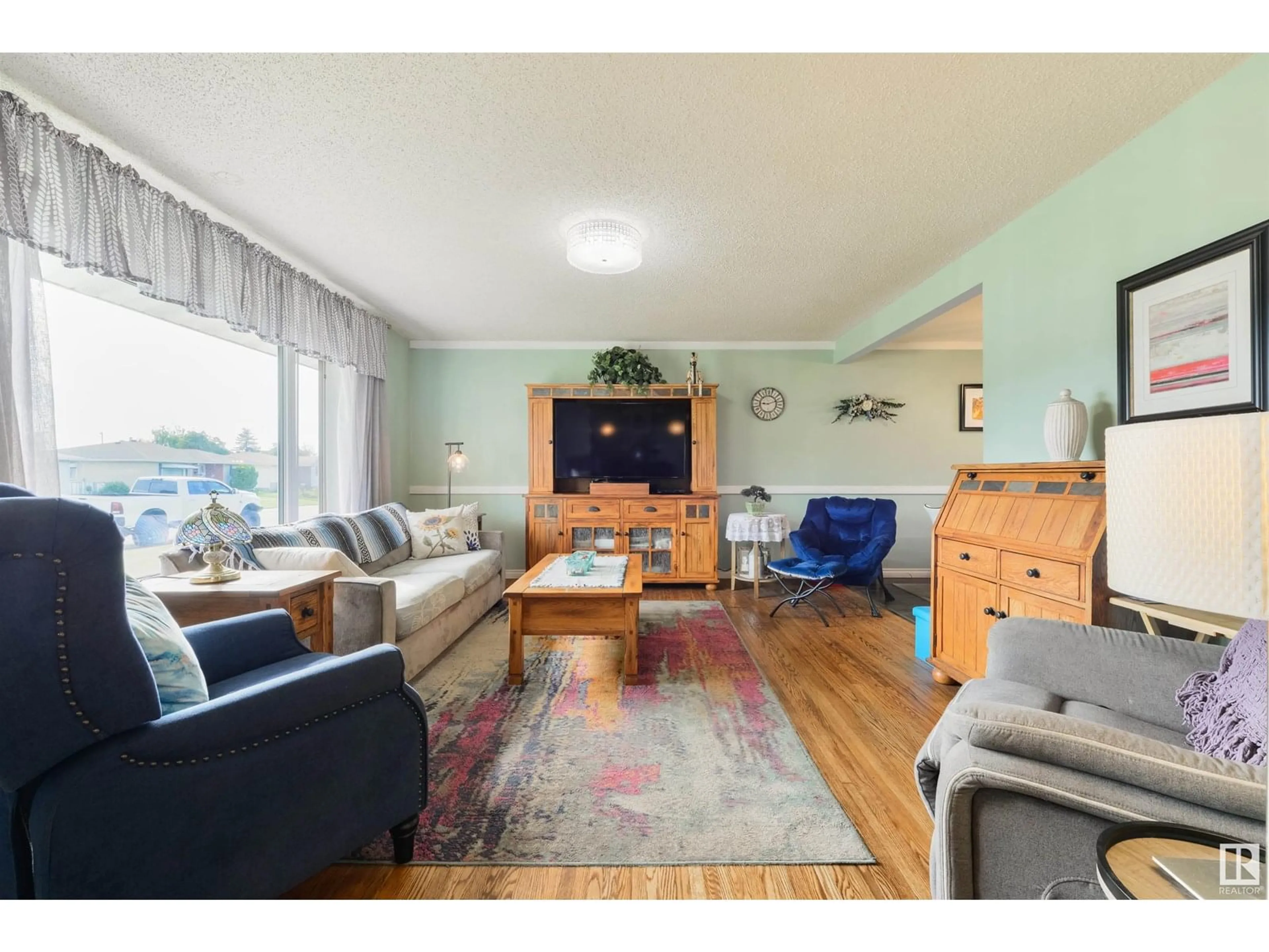 Living room with furniture, wood/laminate floor for 13520 104A ST NW, Edmonton Alberta T5E4R2