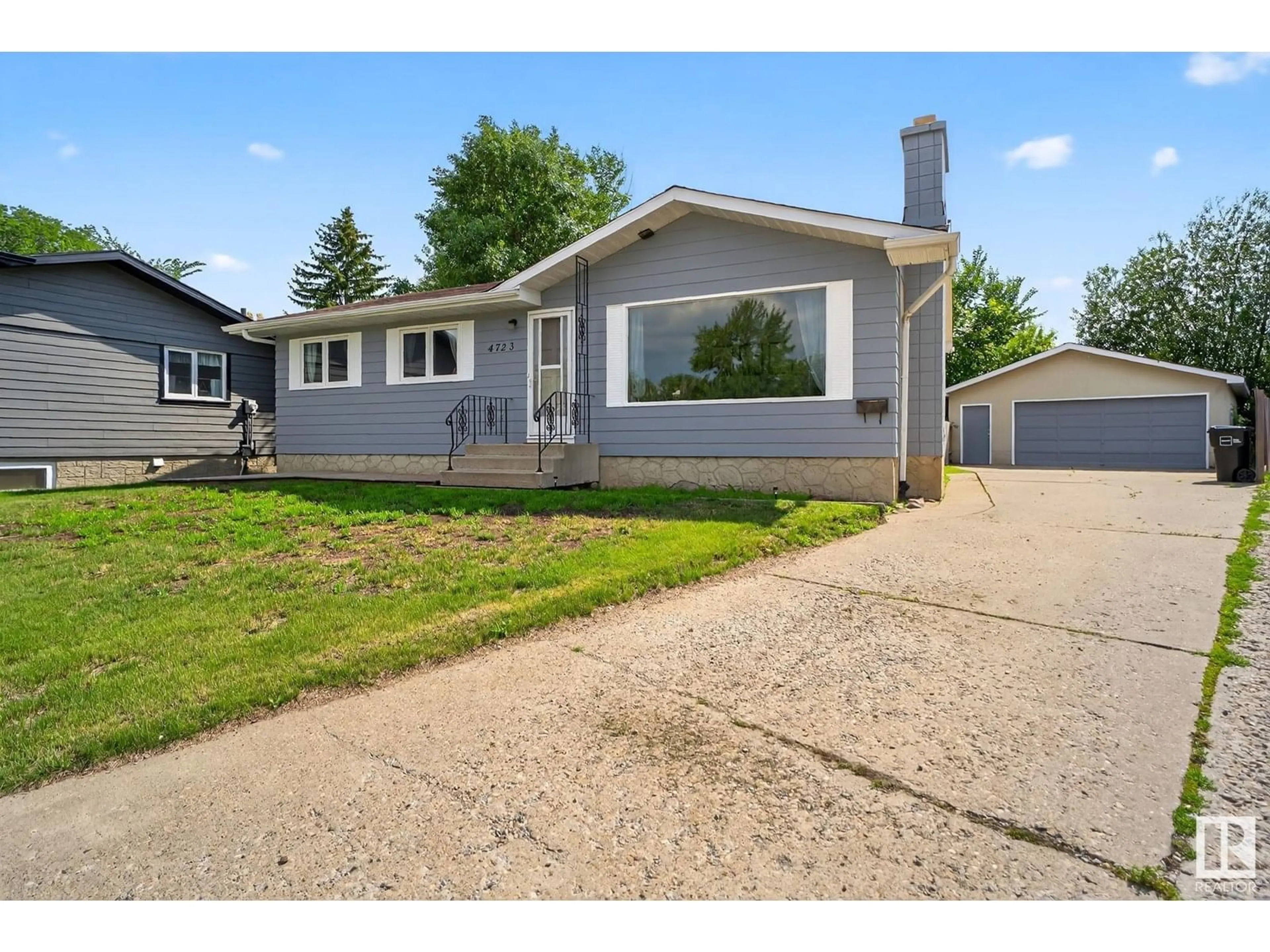 Home with vinyl exterior material, street for NW - 4723 132 AV, Edmonton Alberta T5A3H1