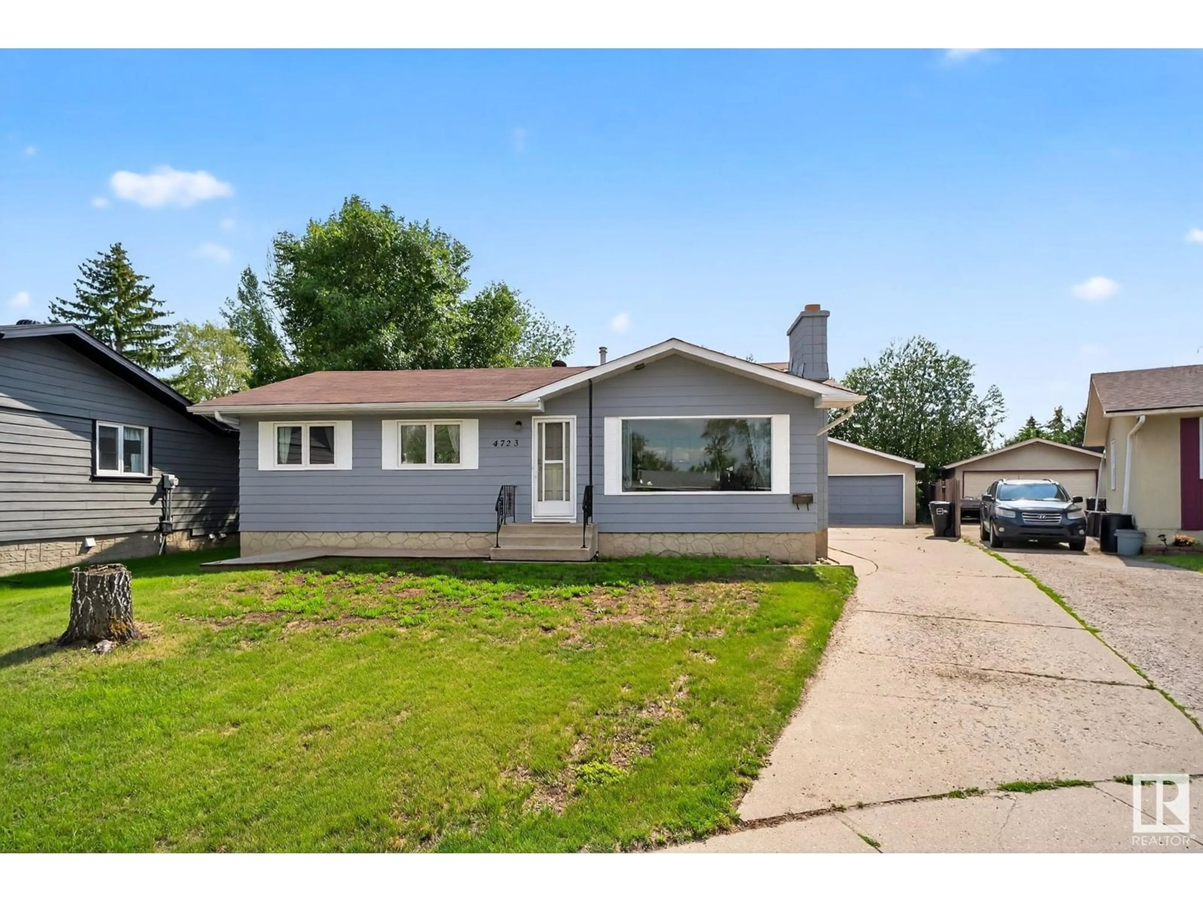 Home with vinyl exterior material, street for NW - 4723 132 AV, Edmonton Alberta T5A3H1