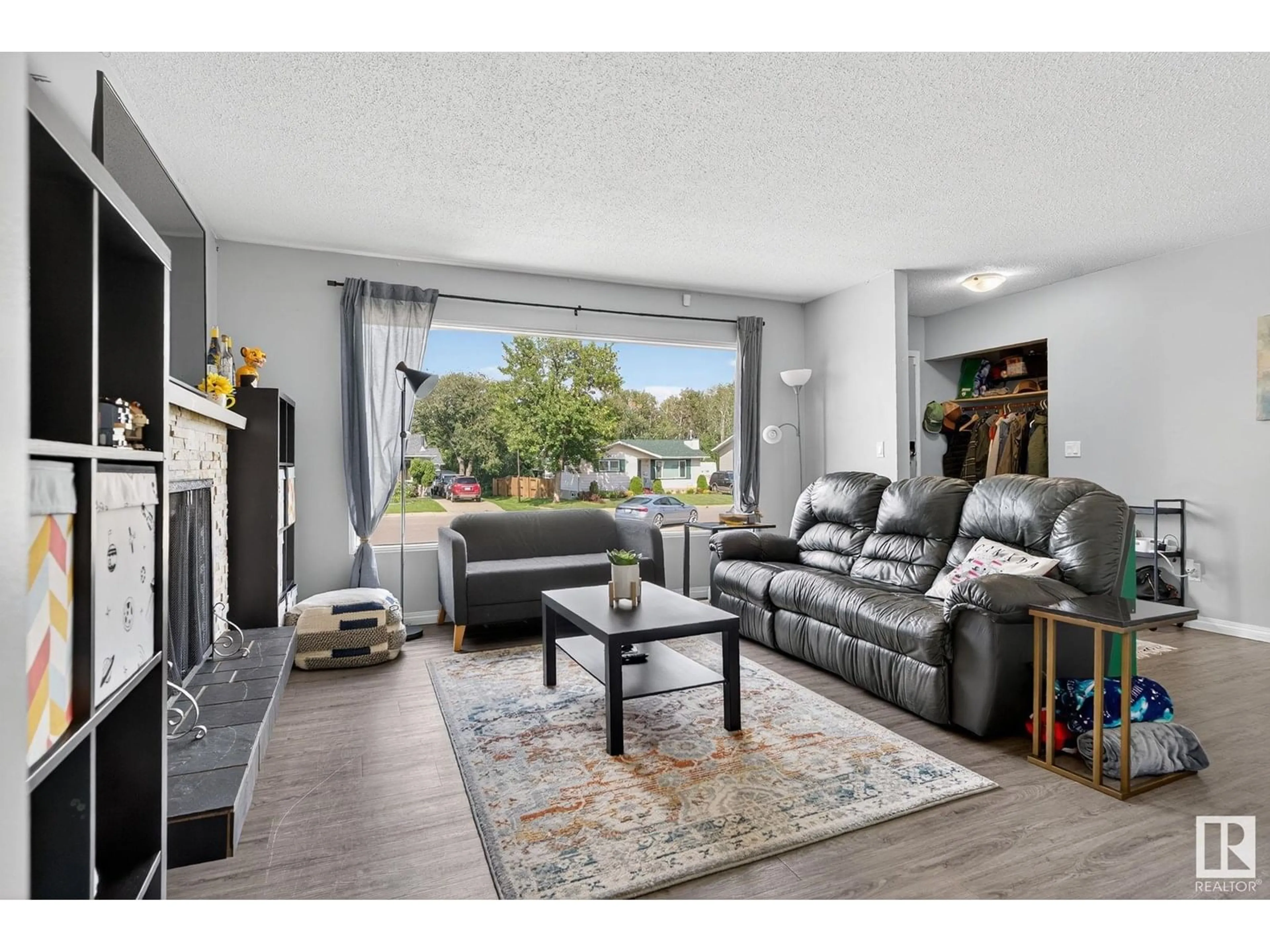 Living room with furniture, wood/laminate floor for NW - 4723 132 AV, Edmonton Alberta T5A3H1