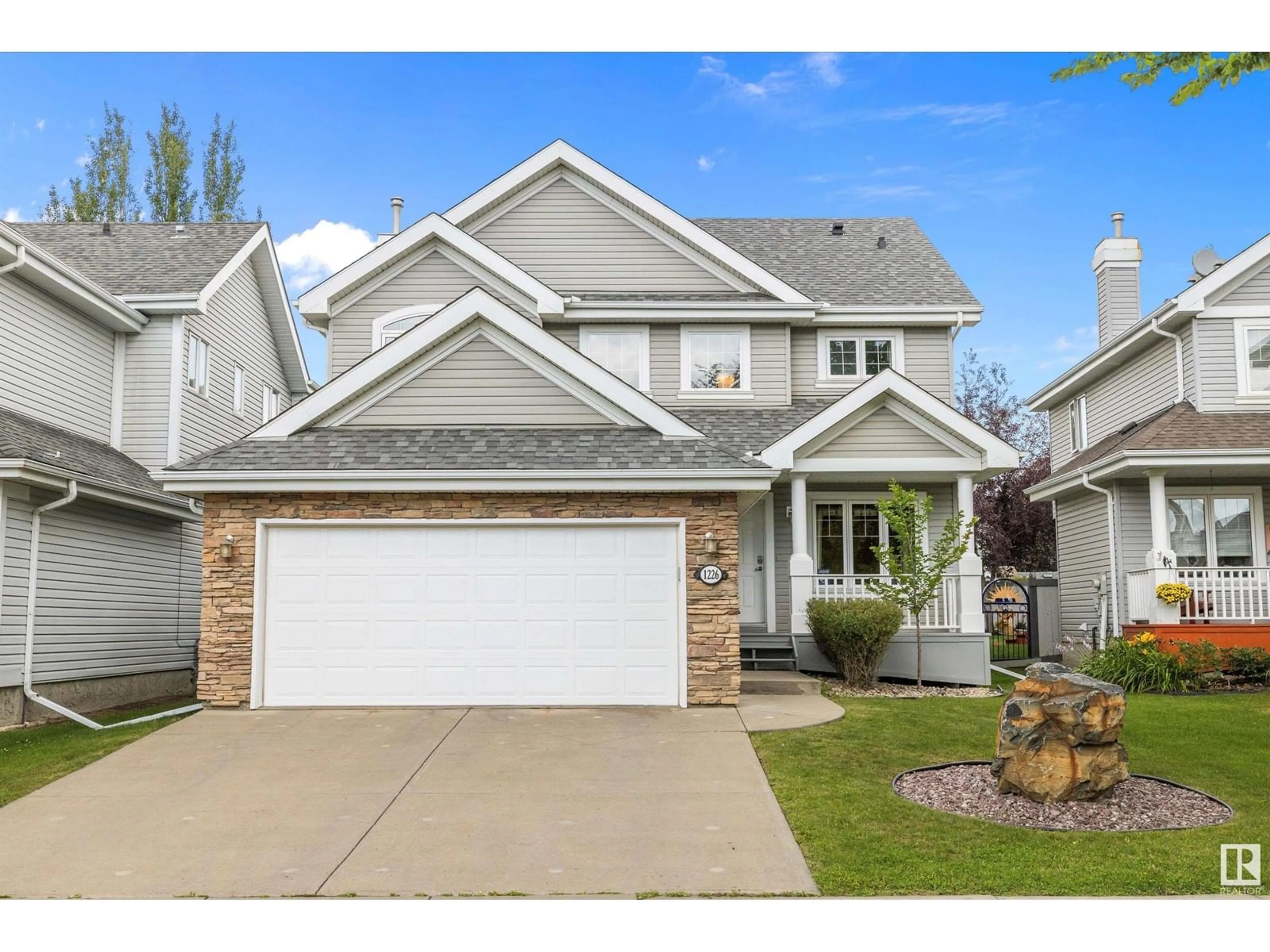 Home with vinyl exterior material, street for 1226 SUMMERSIDE DR, Edmonton Alberta T6X1B4