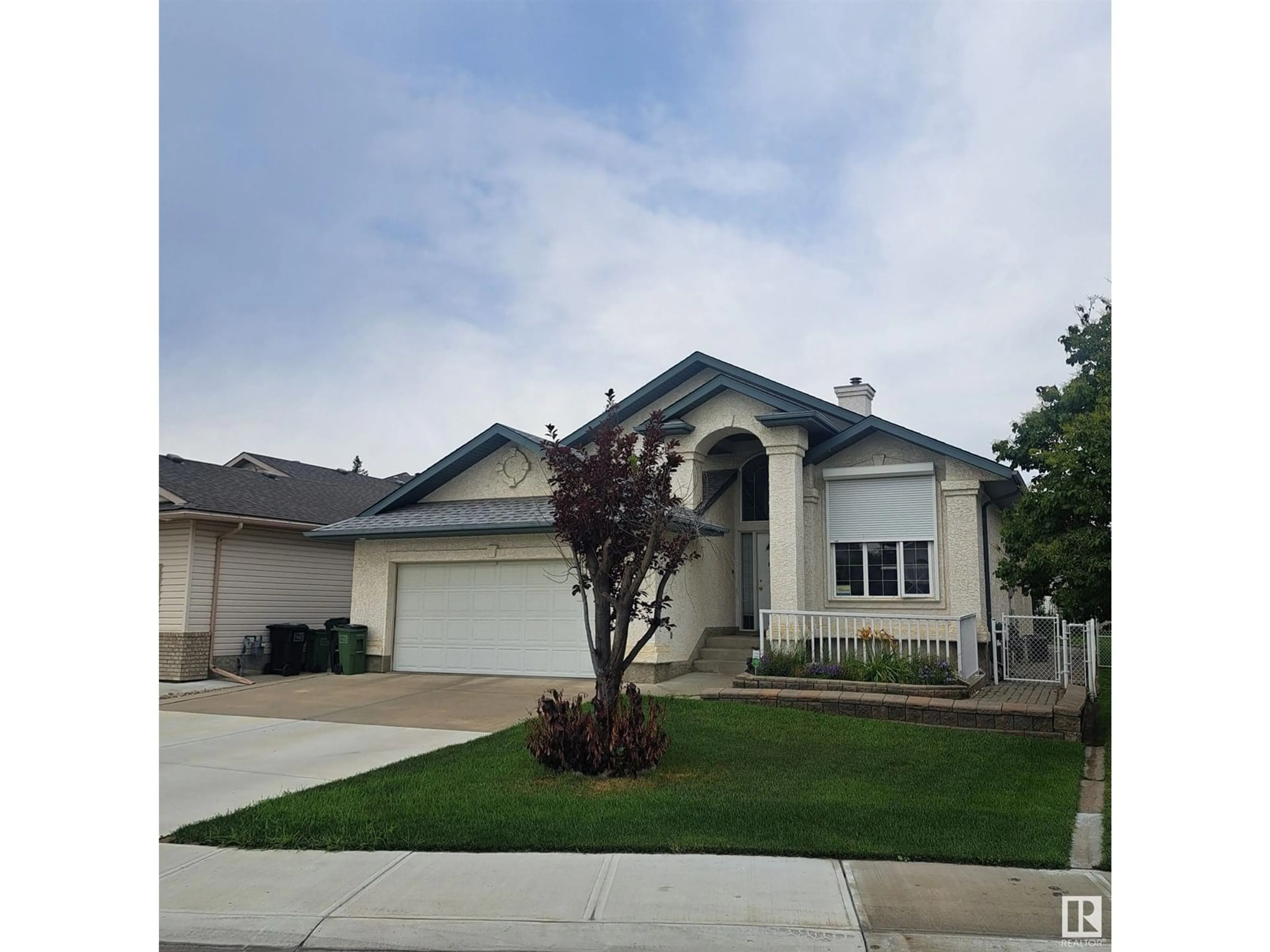 Home with vinyl exterior material, street for NW - 10316 156 AV, Edmonton Alberta T5X6B4