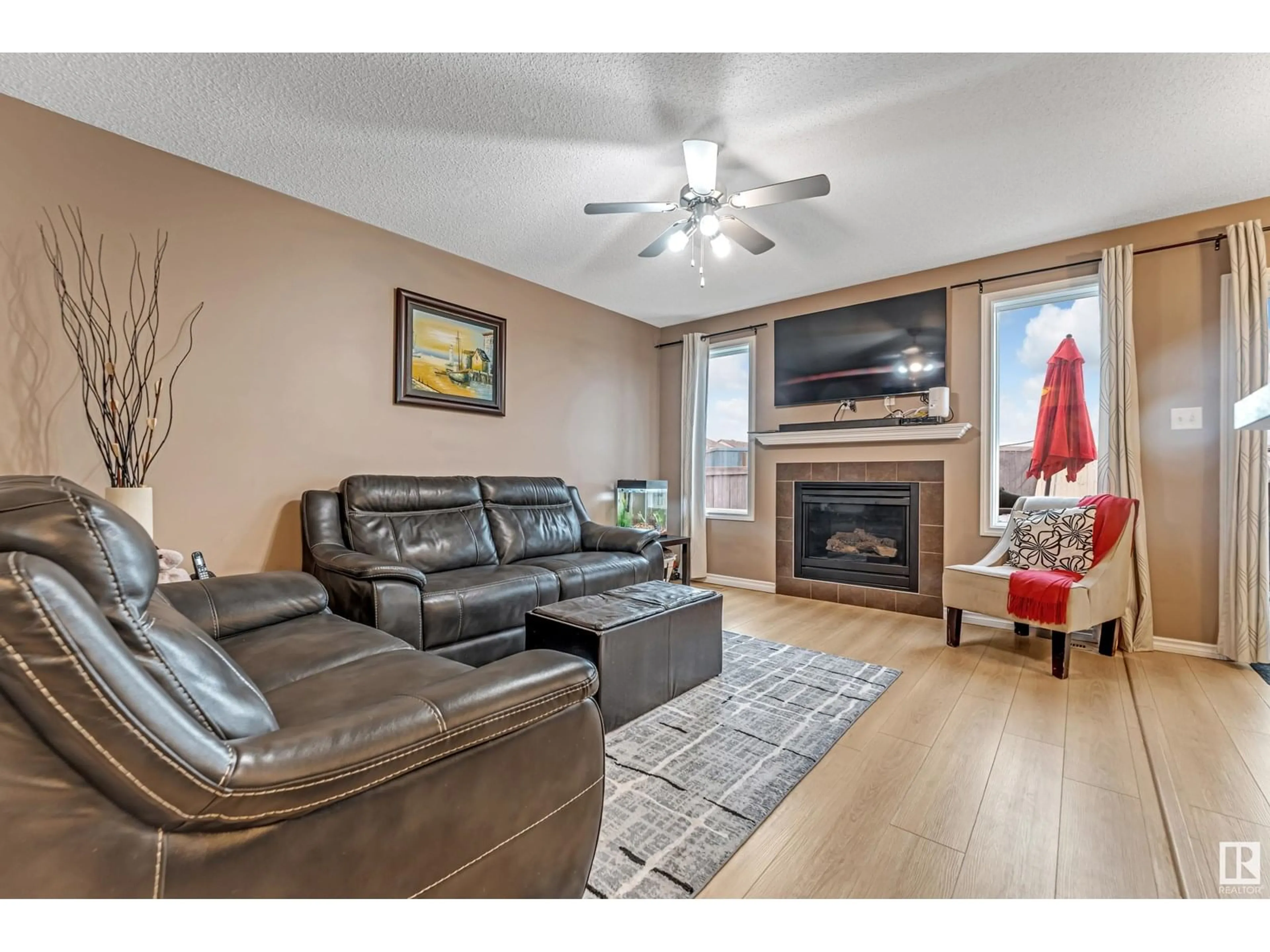 Living room with furniture, wood/laminate floor for 2845 18A AV, Edmonton Alberta T6T0N8