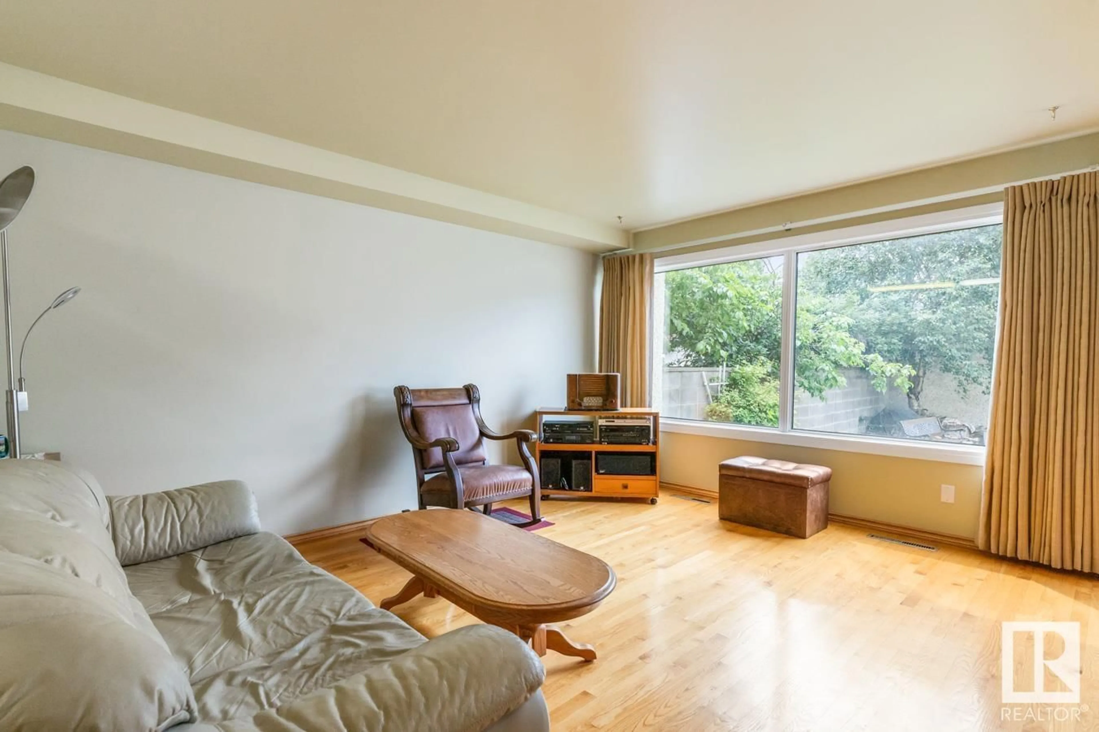 Living room with furniture, wood/laminate floor for 11311 UNIVERSITY AV, Edmonton Alberta T6G1Y8