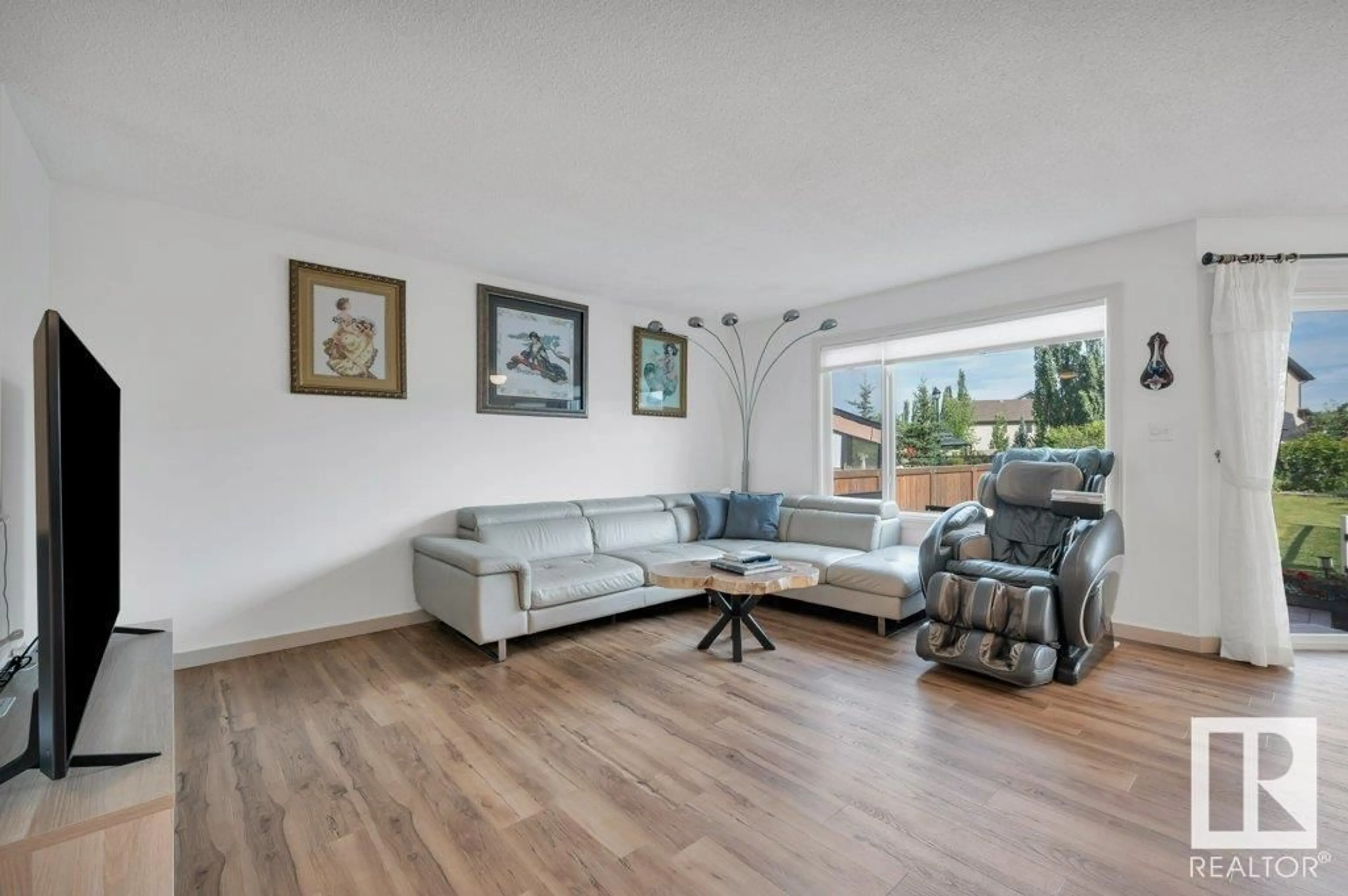 Living room with furniture, wood/laminate floor for SW - 6004 5 AV, Edmonton Alberta T6X0E9