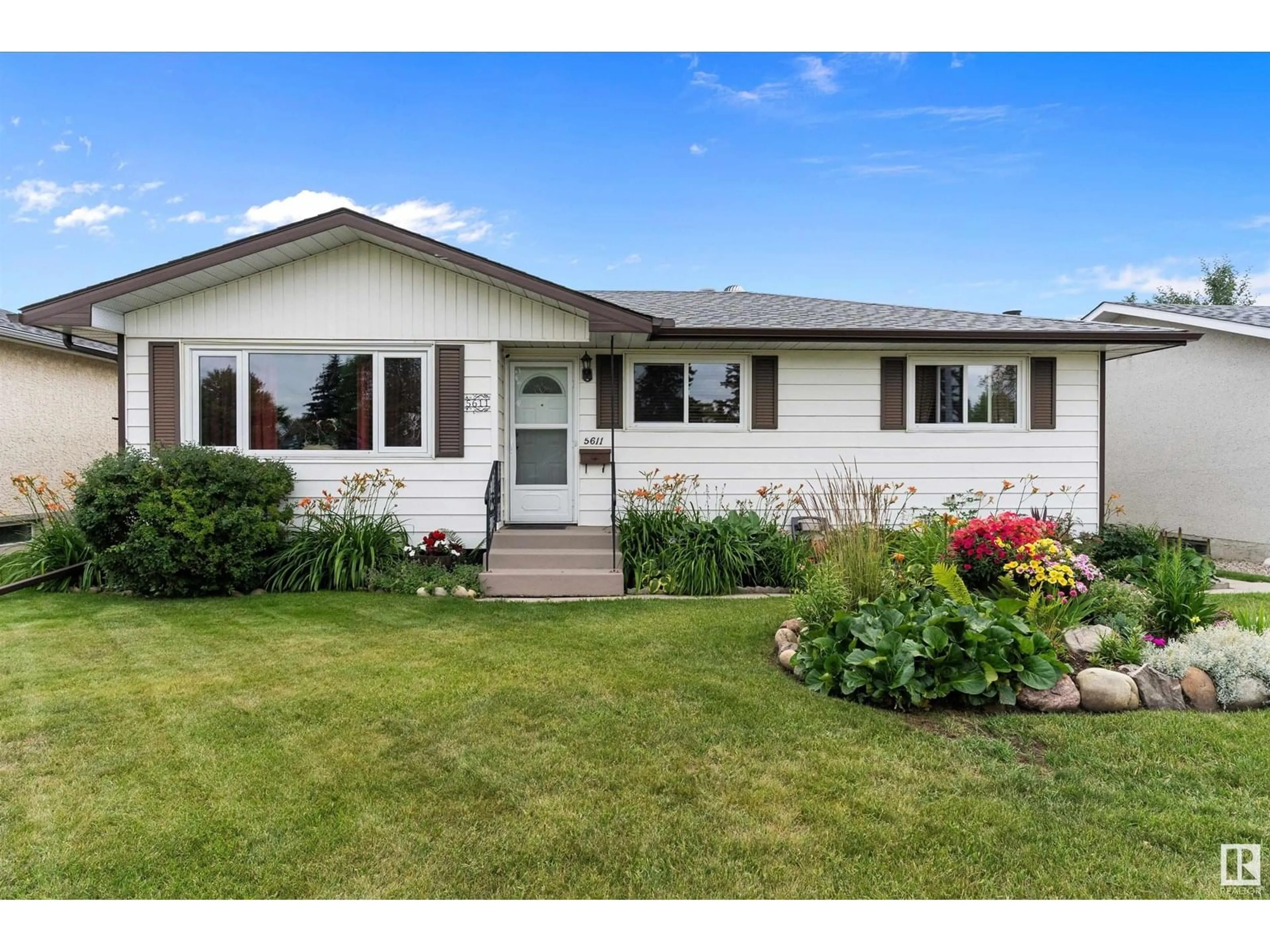 Home with vinyl exterior material, street for 5611 142 AV, Edmonton Alberta T5A1J1