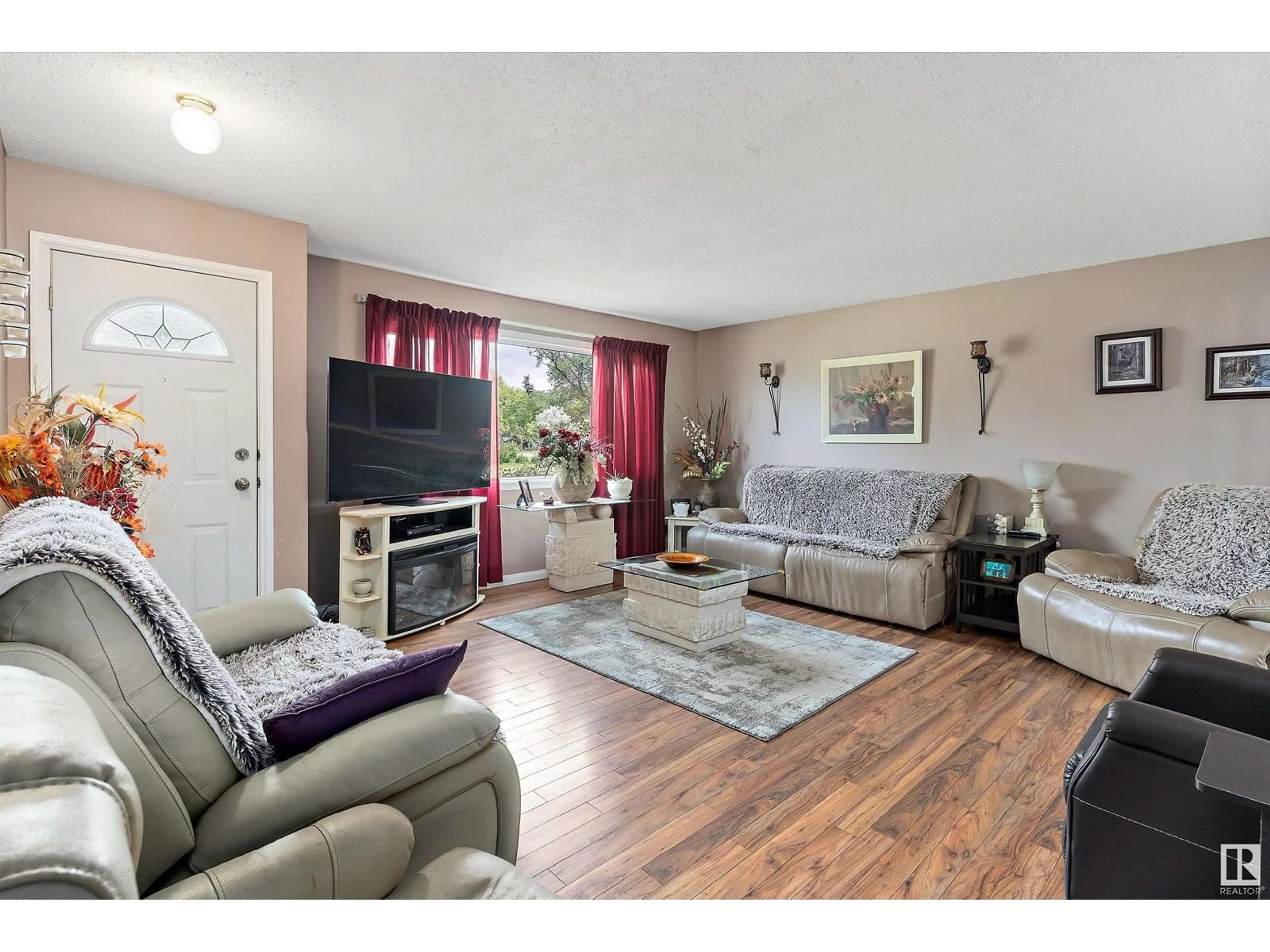 Living room with furniture, wood/laminate floor for 5611 142 AV, Edmonton Alberta T5A1J1