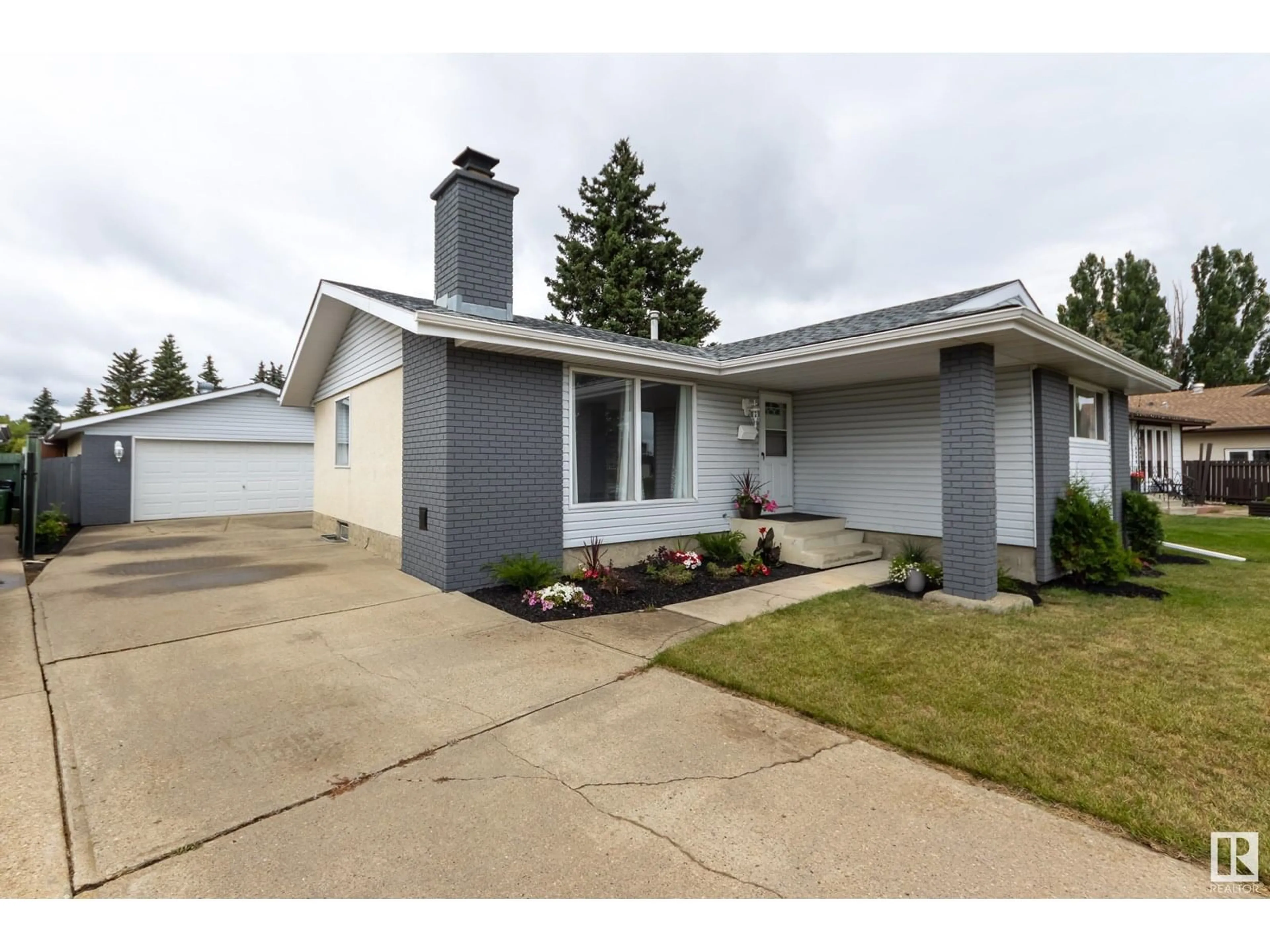 Home with vinyl exterior material, street for NW - 15228 122 ST, Edmonton Alberta T5X1P5