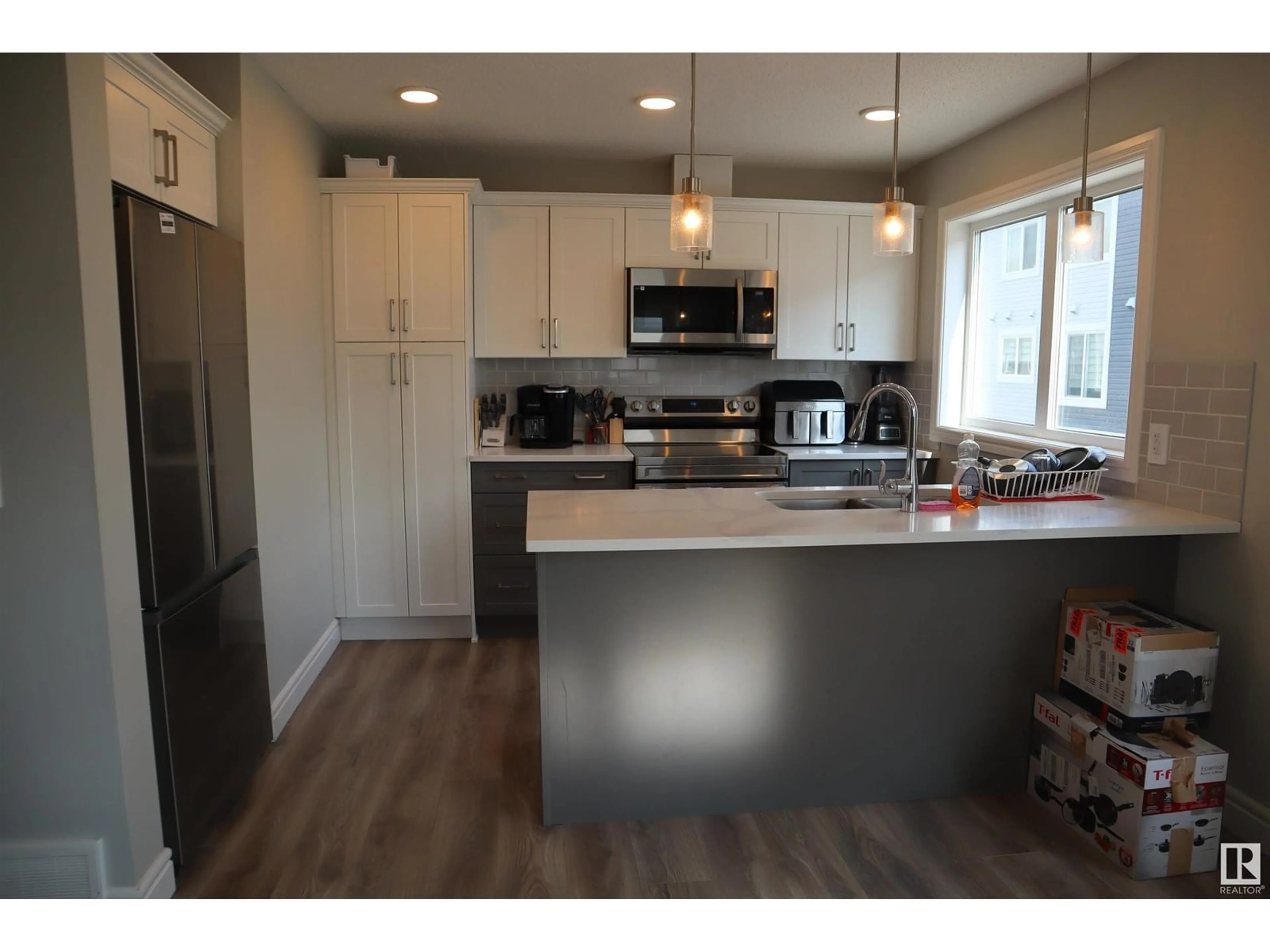 Open concept kitchen, wood/laminate floor for 76 16335 84 ST NW, Edmonton Alberta T5Z0S2